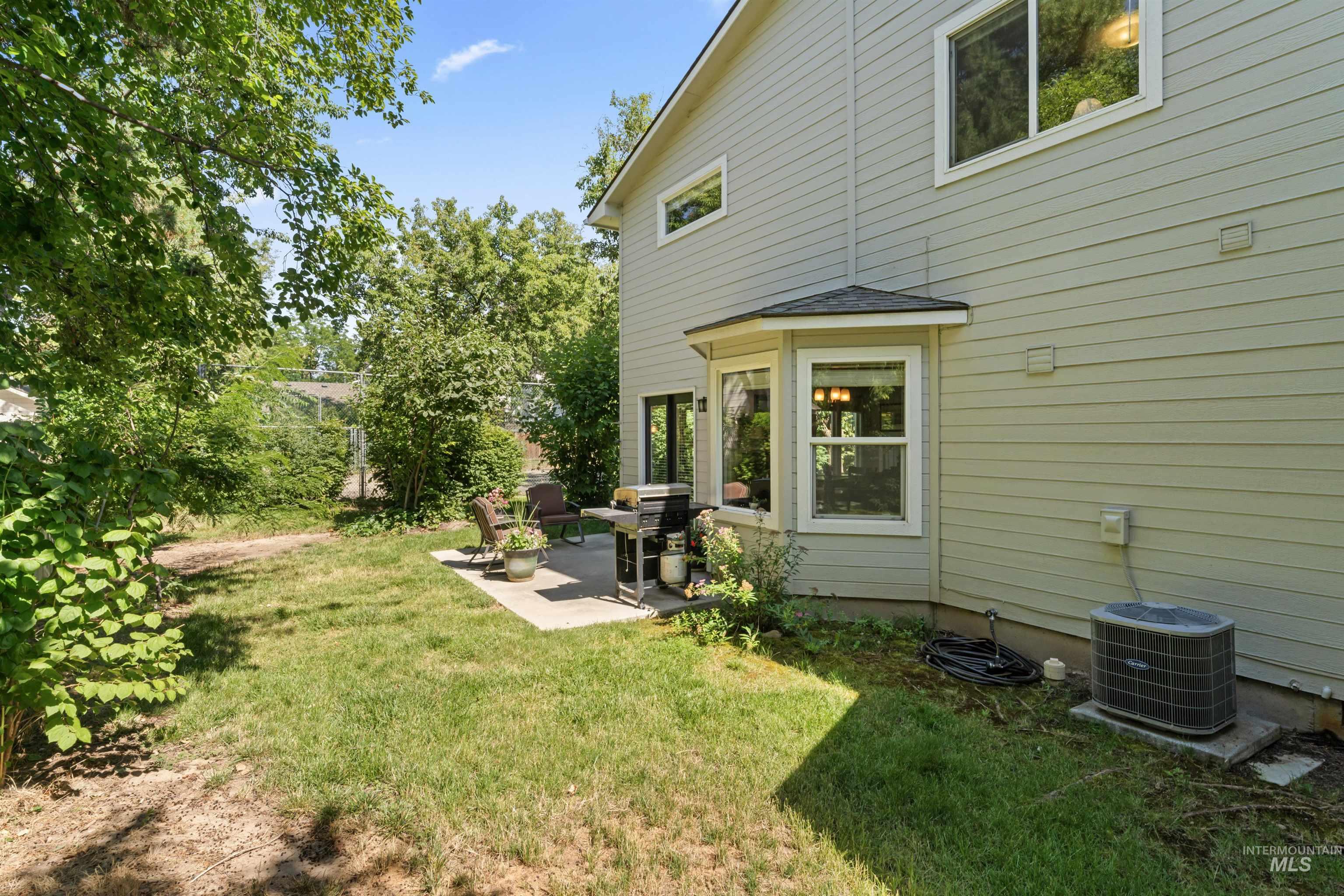 View of green lawn featuring a patio