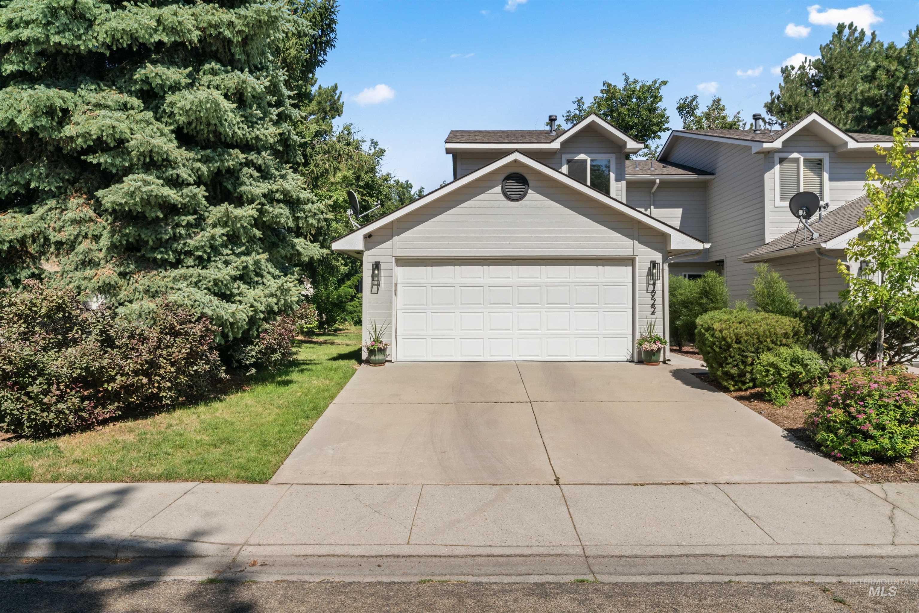 Traditional home featuring concrete driveway