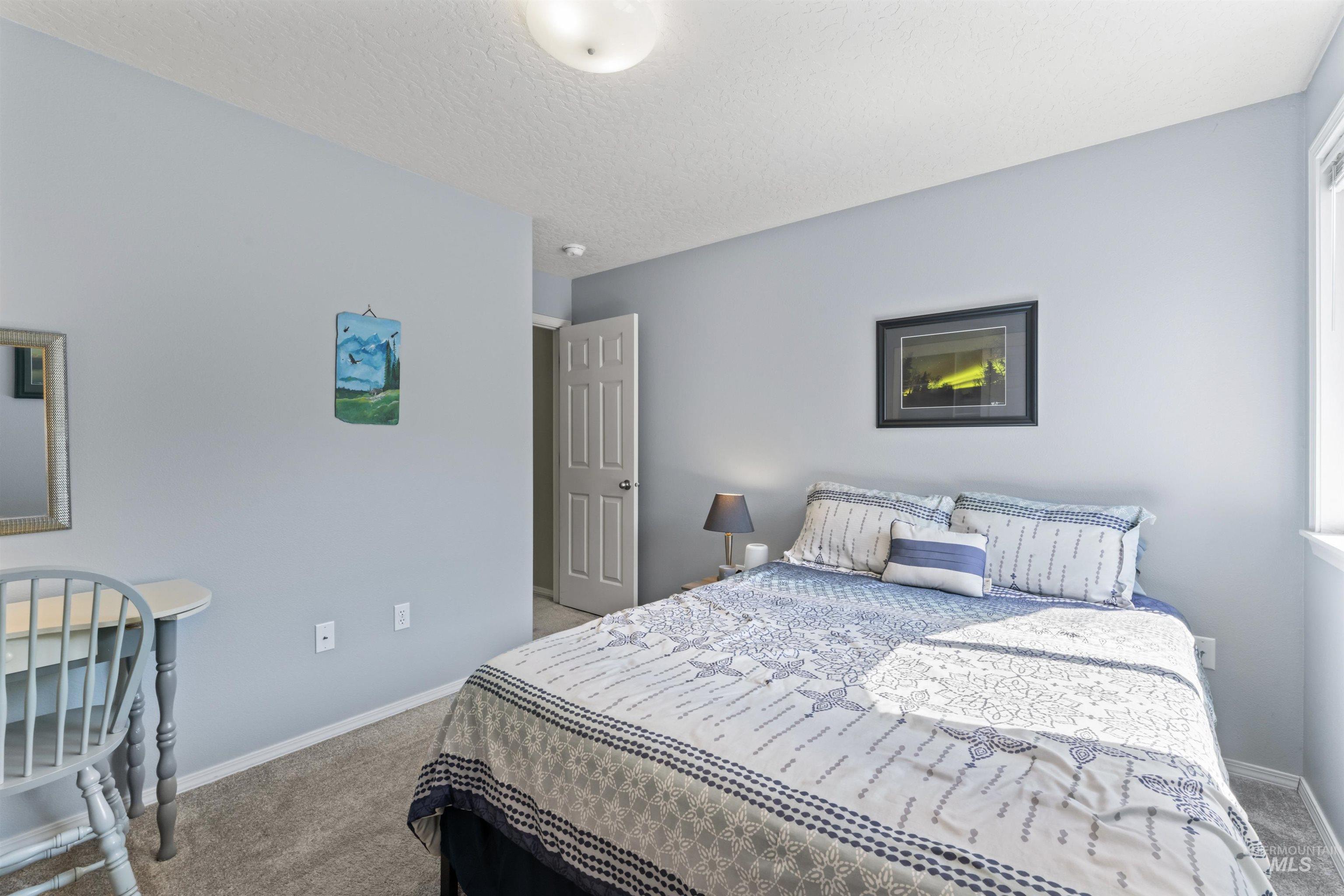 Bedroom with carpet flooring and baseboards