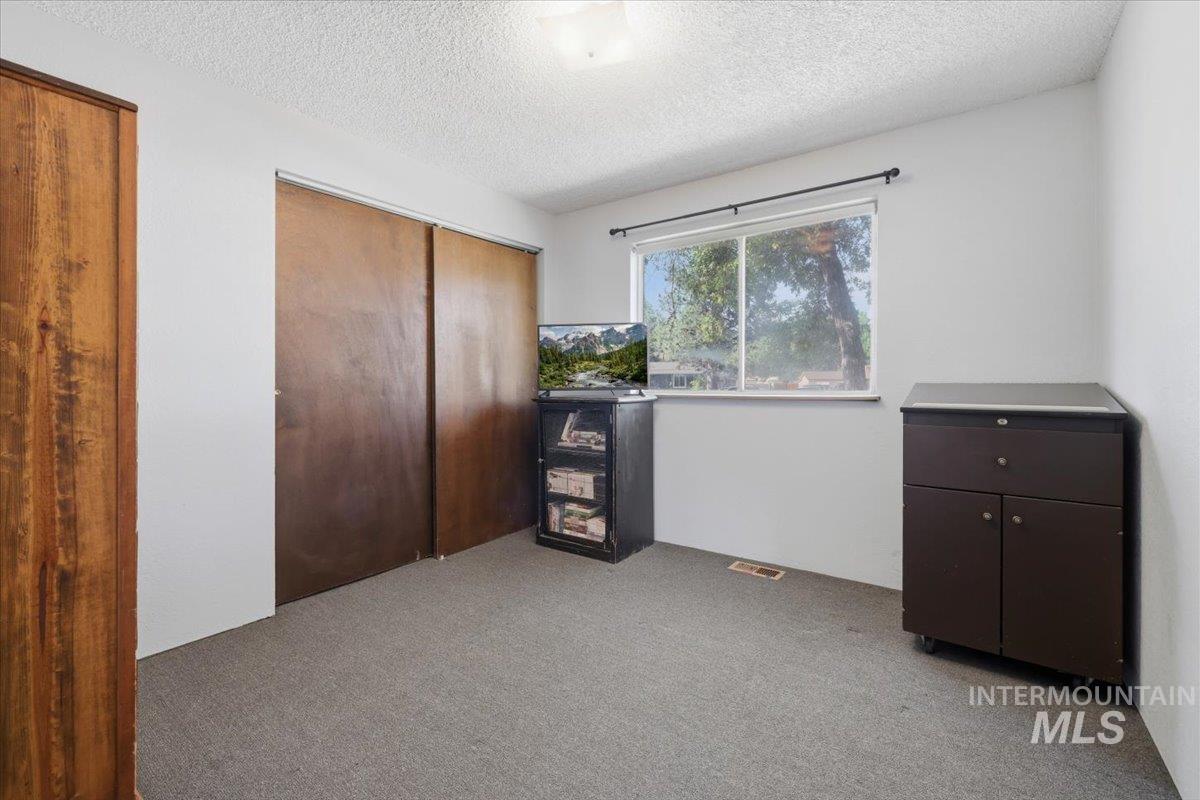 Room with neutral gray carpet and white walls
