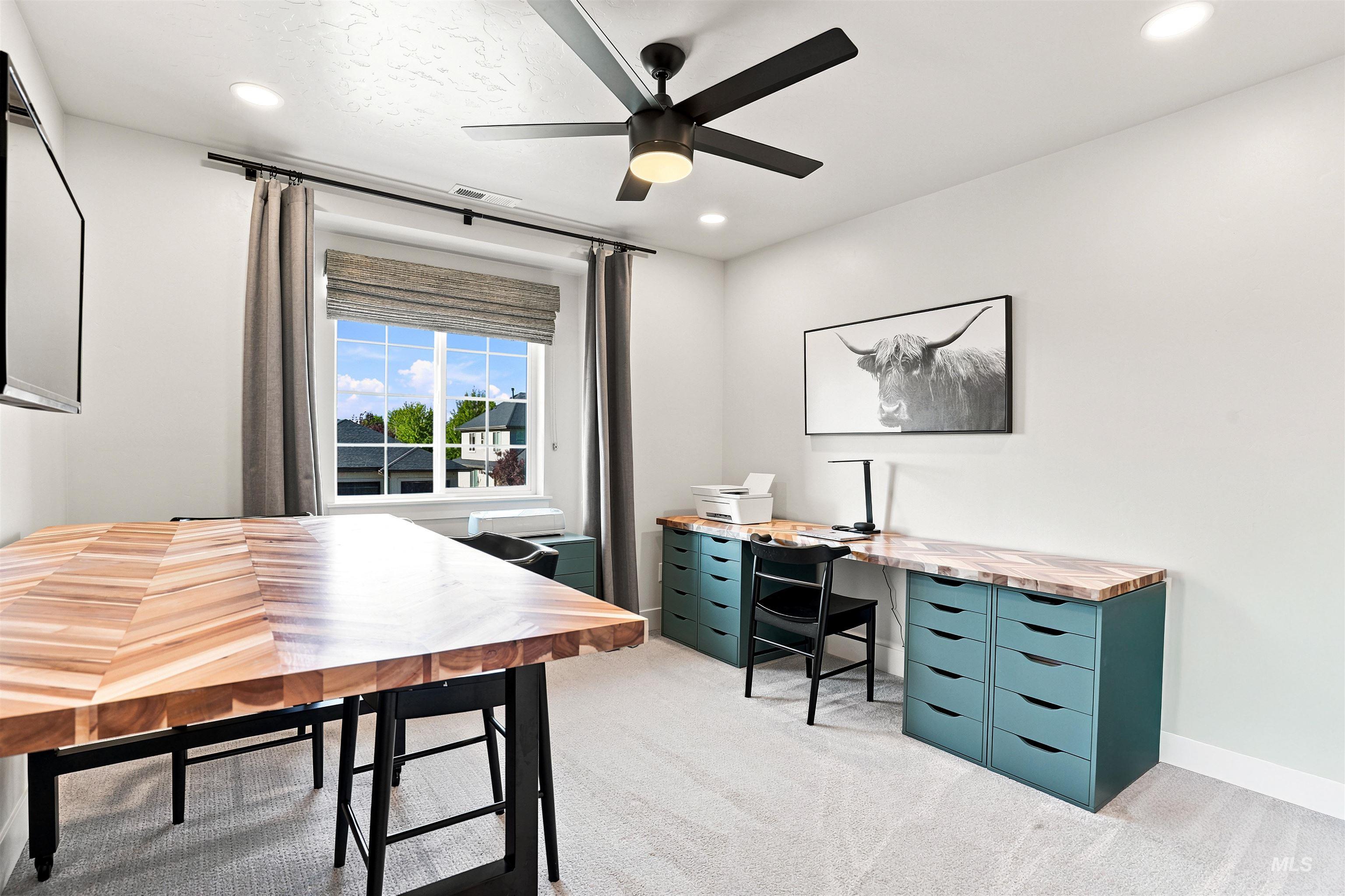 Bright room featuring a multi-pane window, recessed lighting, and a ceiling fan
