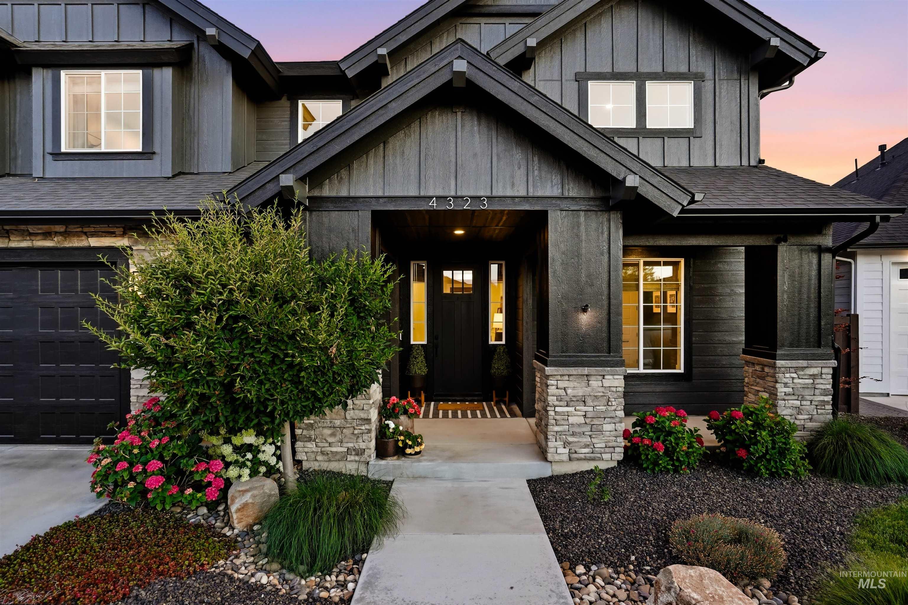 Contemporary exterior featuring dark vertical siding and stone accents