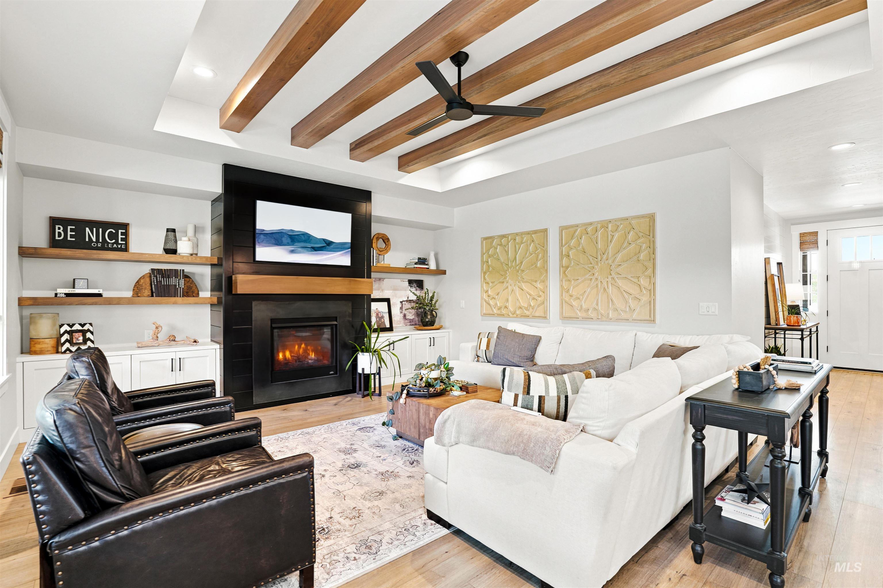 Living area featuring wood-finish flooring and a coffered ceiling with exposed wood beams