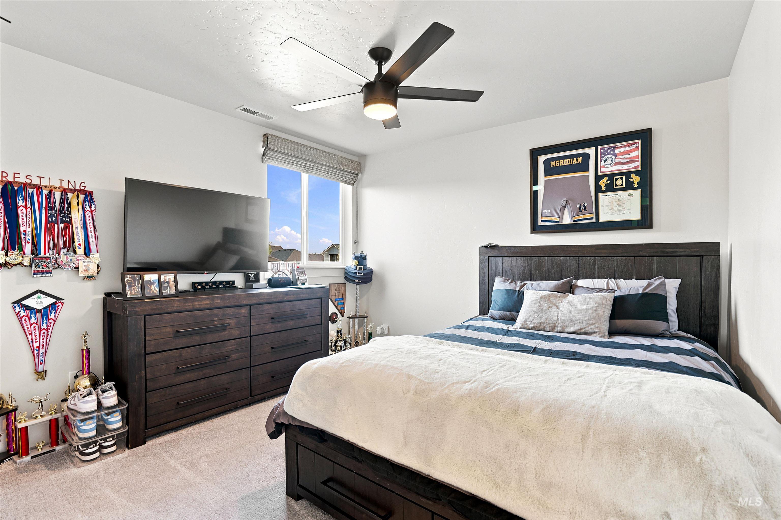 Bedroom featuring light gray carpeting and white walls
