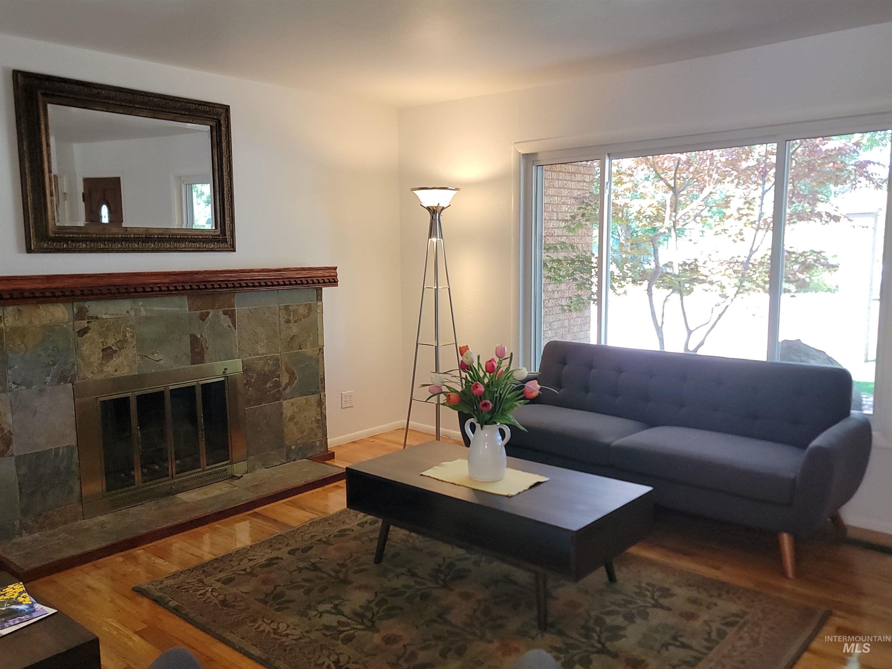 Living room with wood finished floors and a fireplace