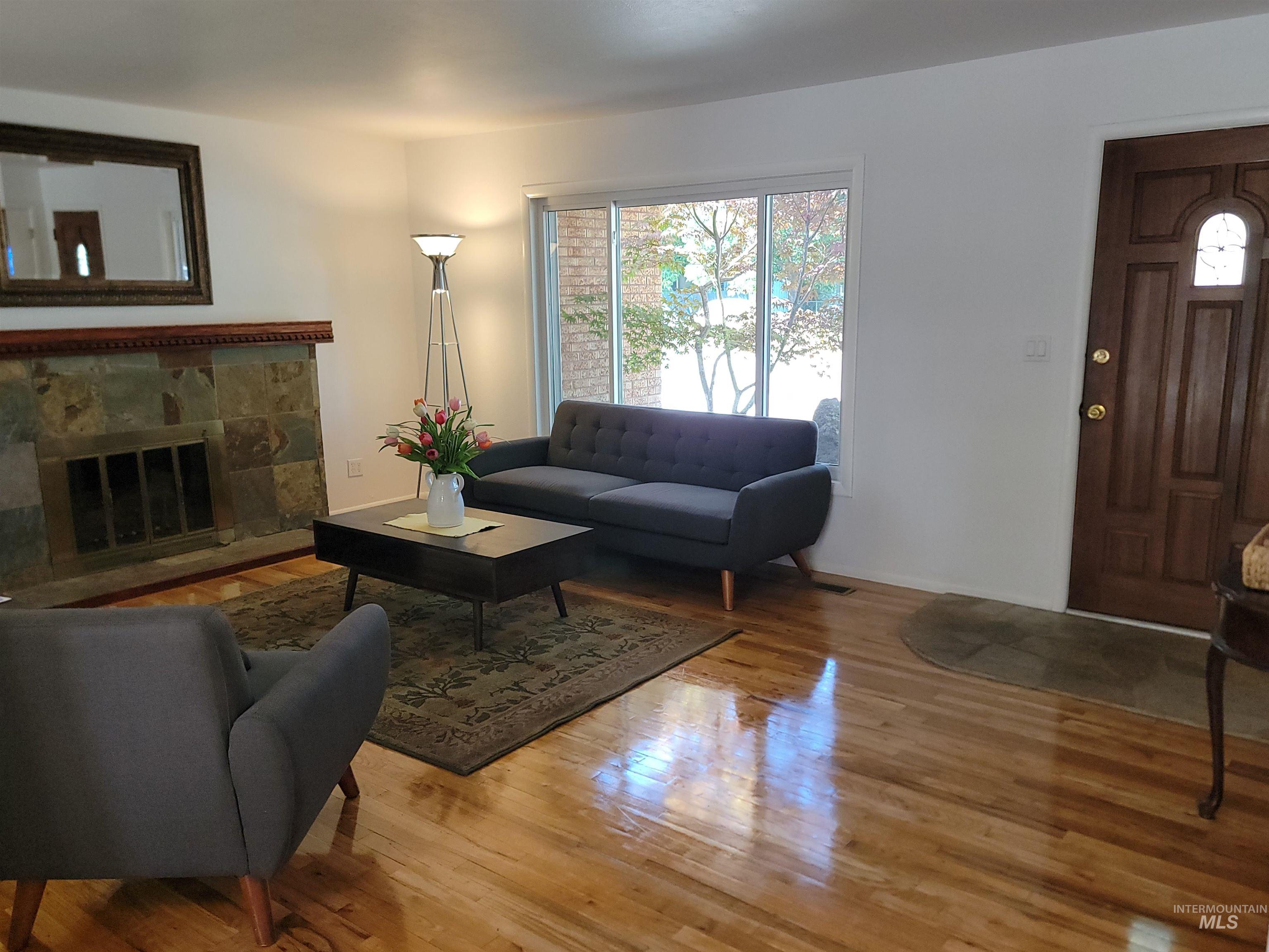 Living area featuring wood finished floors and a fireplace