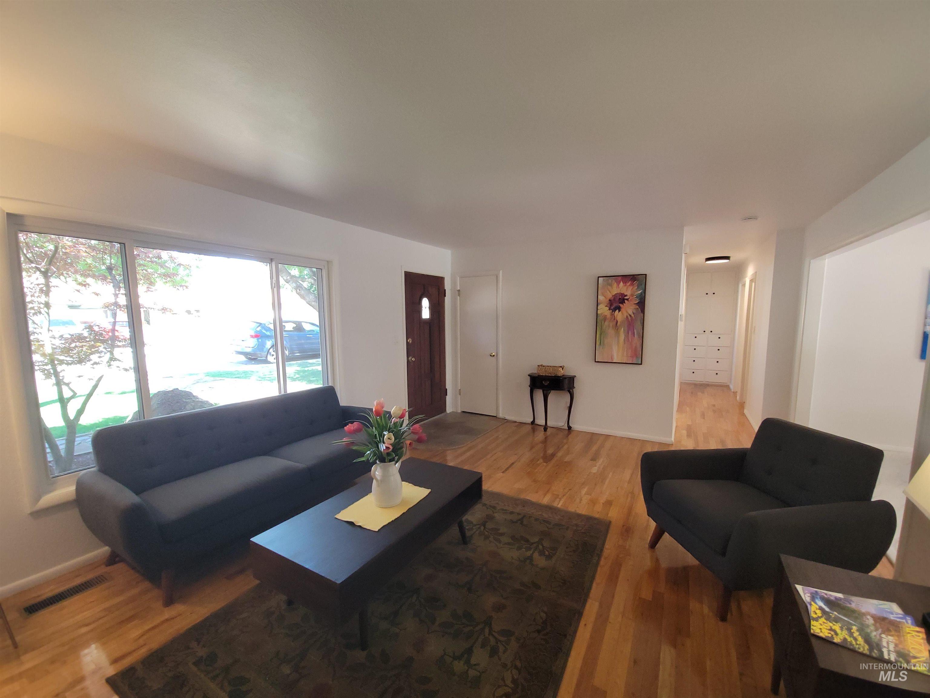 Living room with light wood-style floors and baseboards