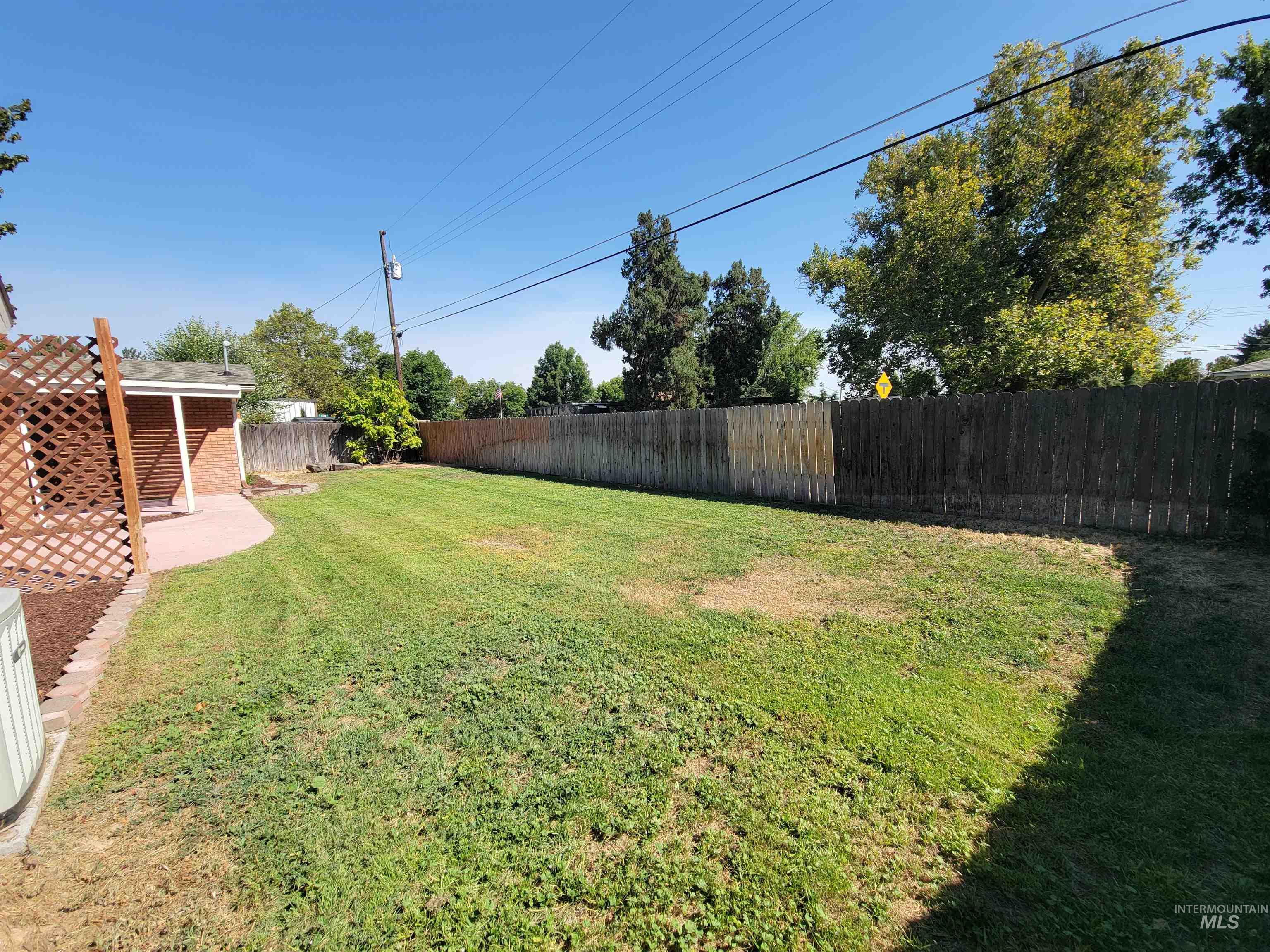Fenced backyard featuring a patio