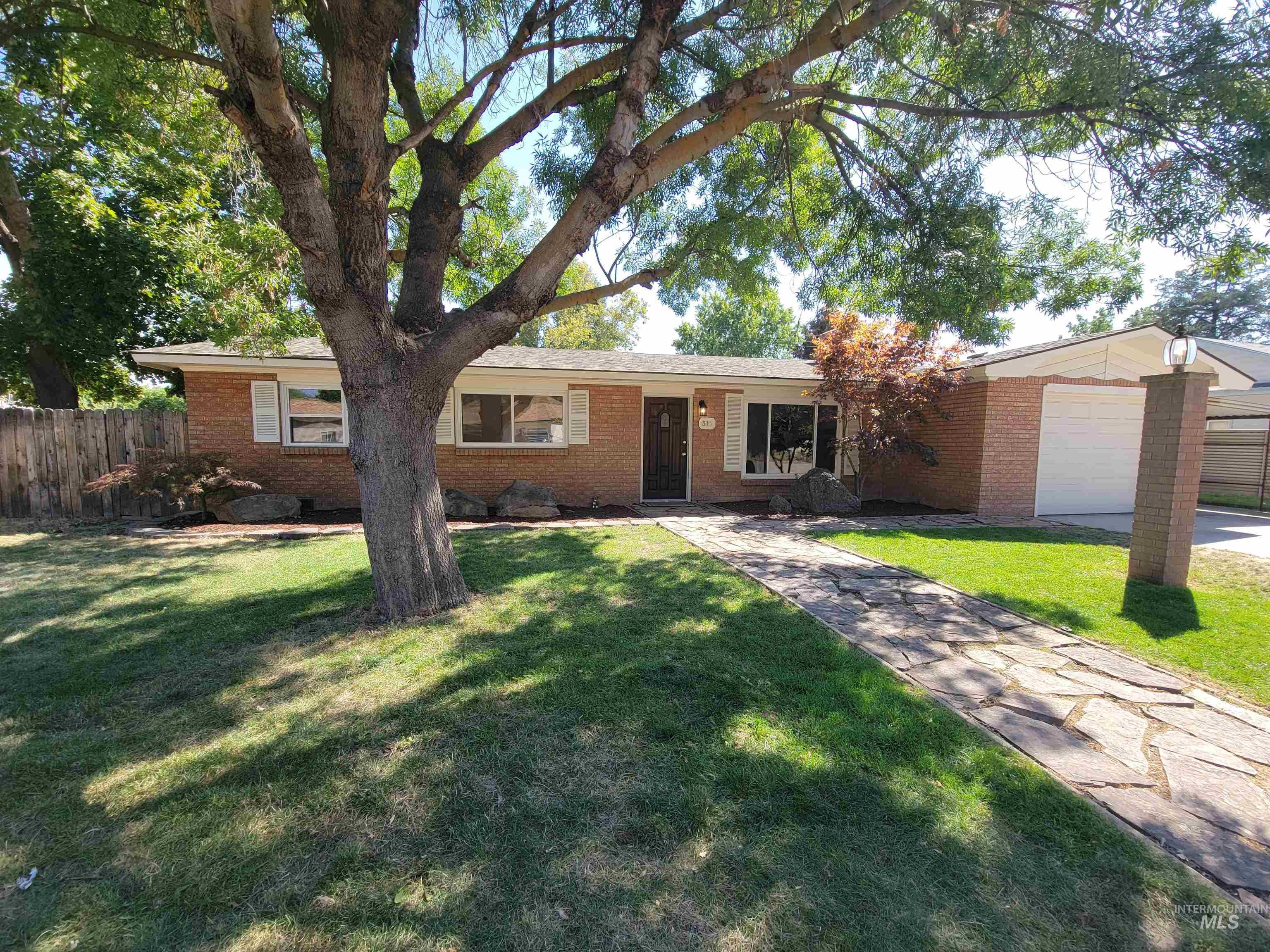 Single story home with brick siding and an attached garage