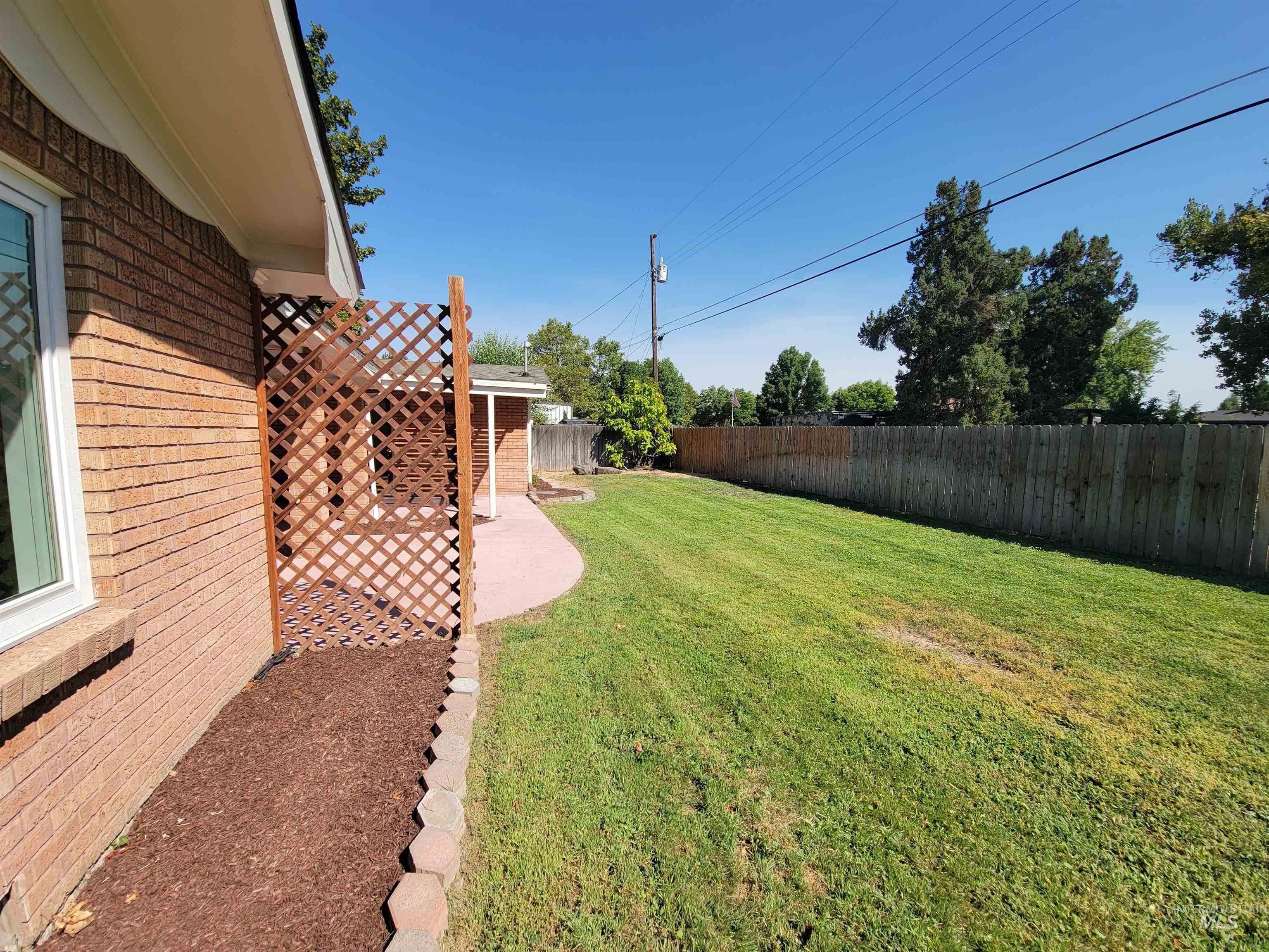 Fenced backyard with a patio