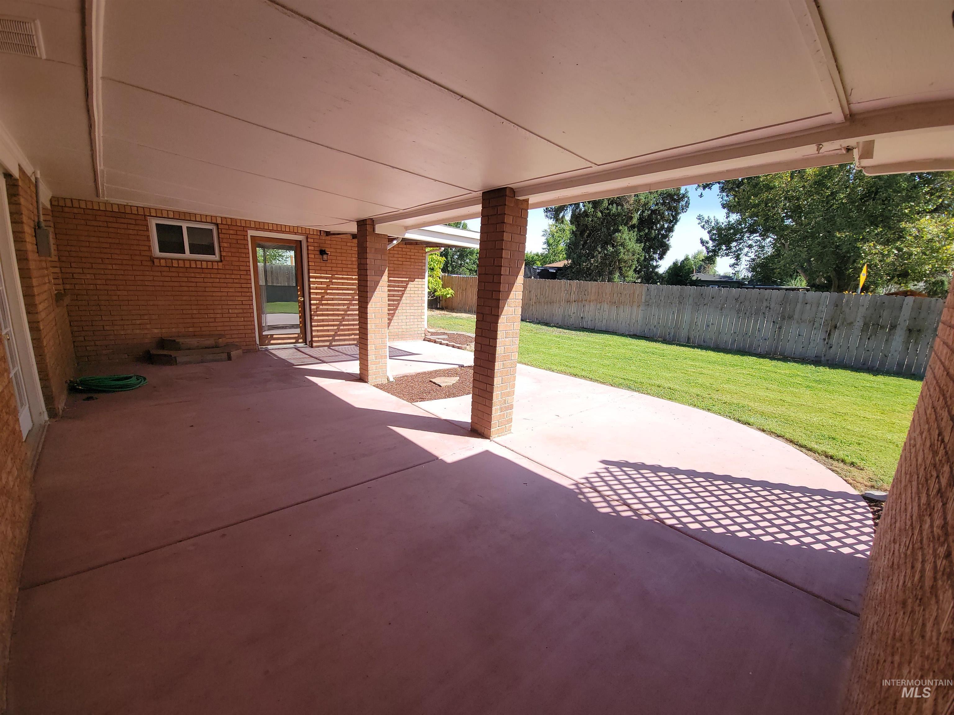 Fenced backyard featuring a patio