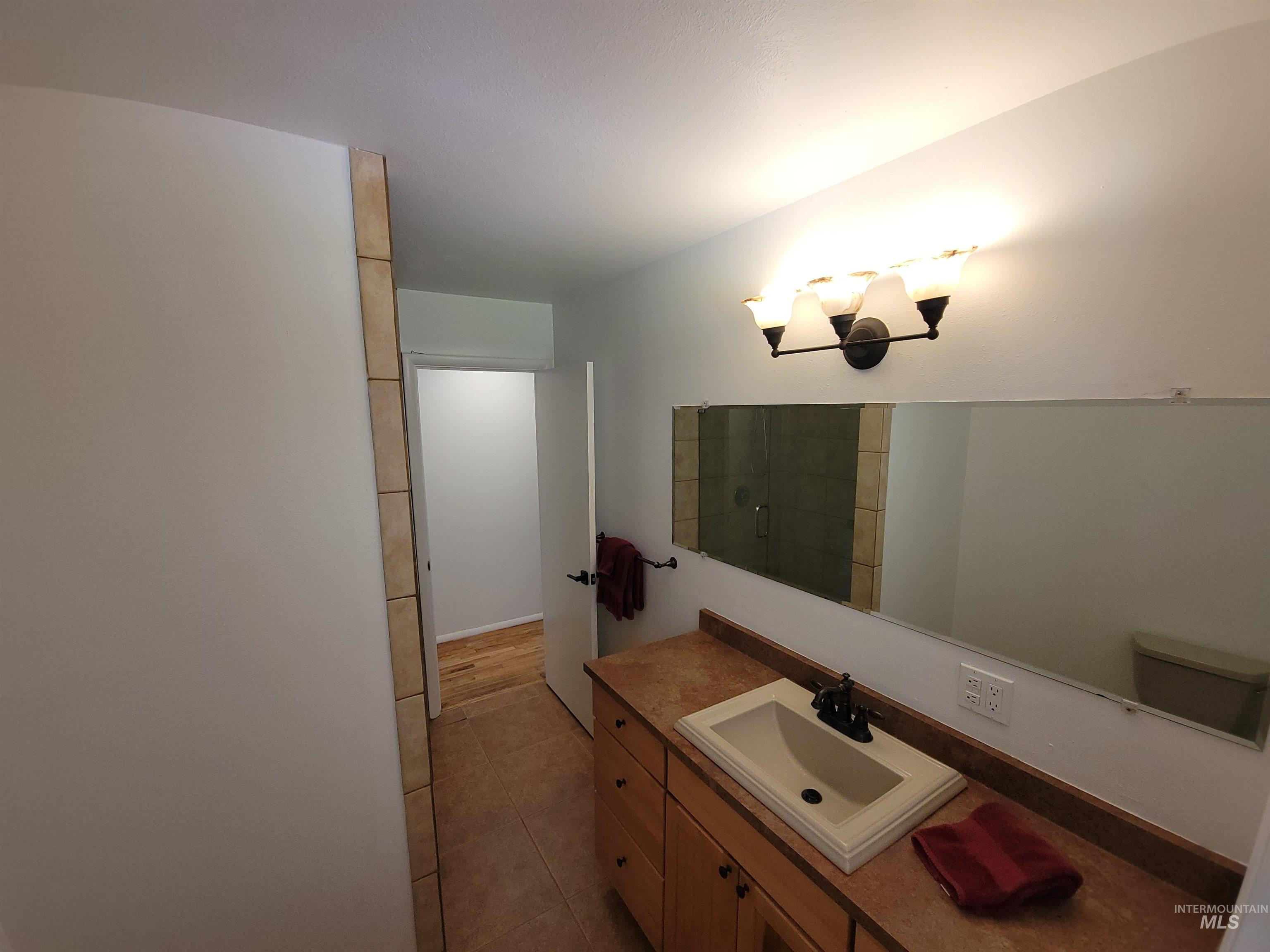Bathroom with vanity and light tile patterned floors