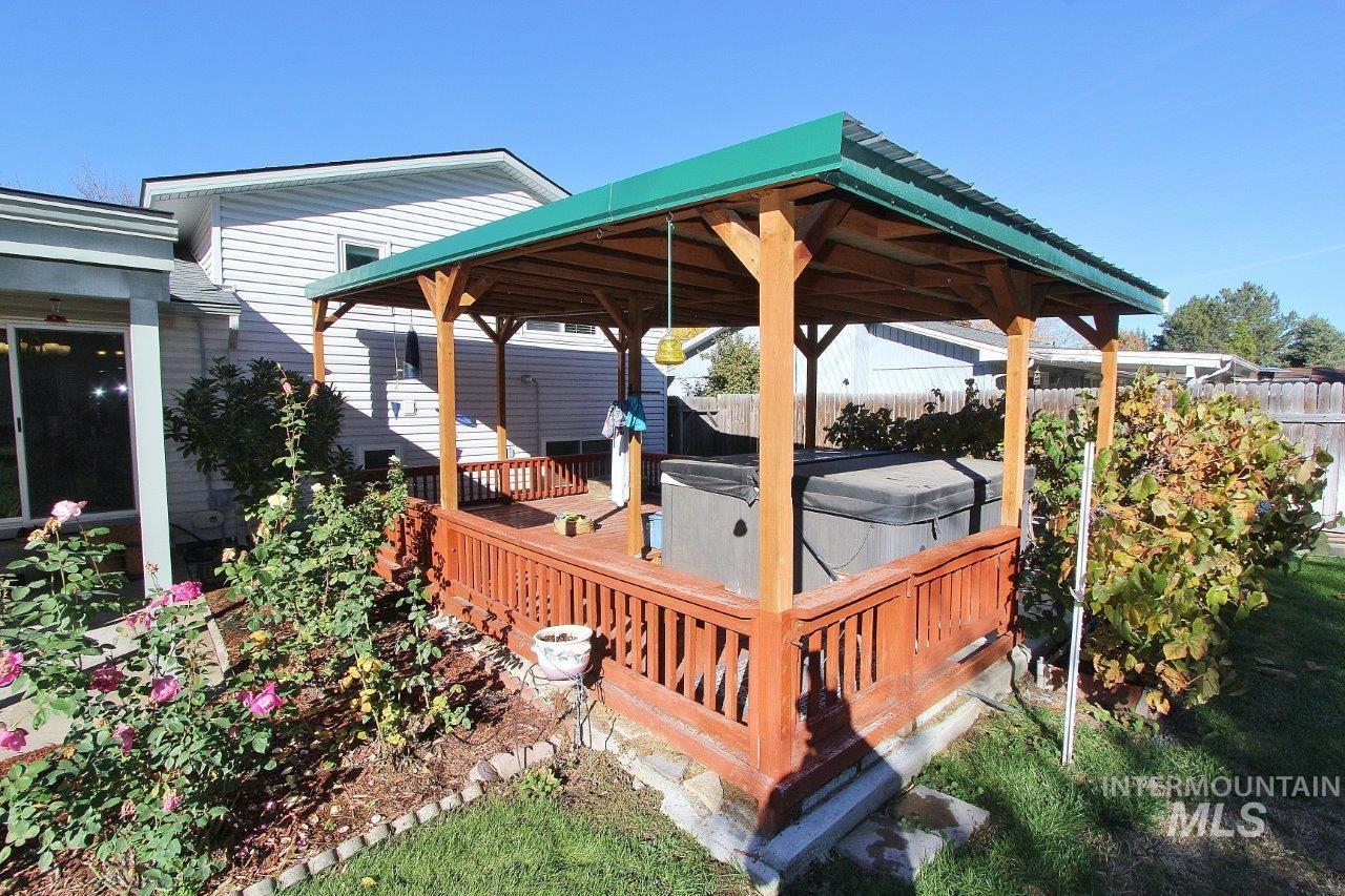 Wooden deck with a hot tub and a gazebo