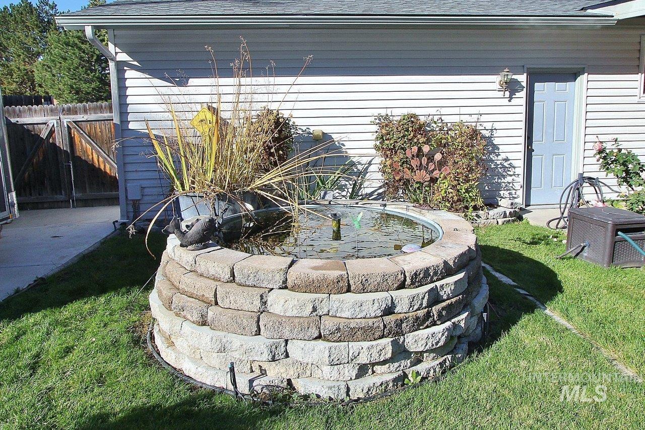 Exterior view of roof with shingles, a downspout, and gutters