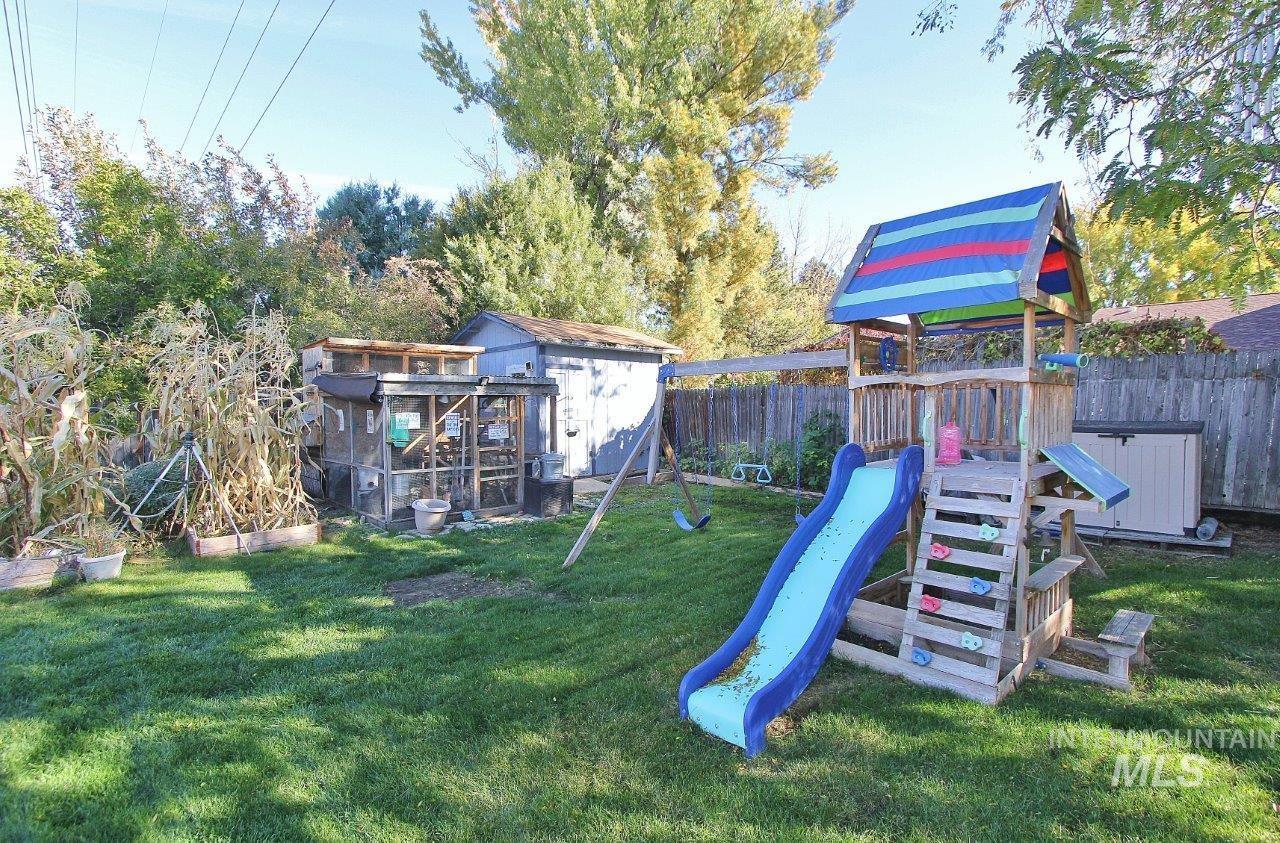 View of play area featuring a shed and a fenced backyard