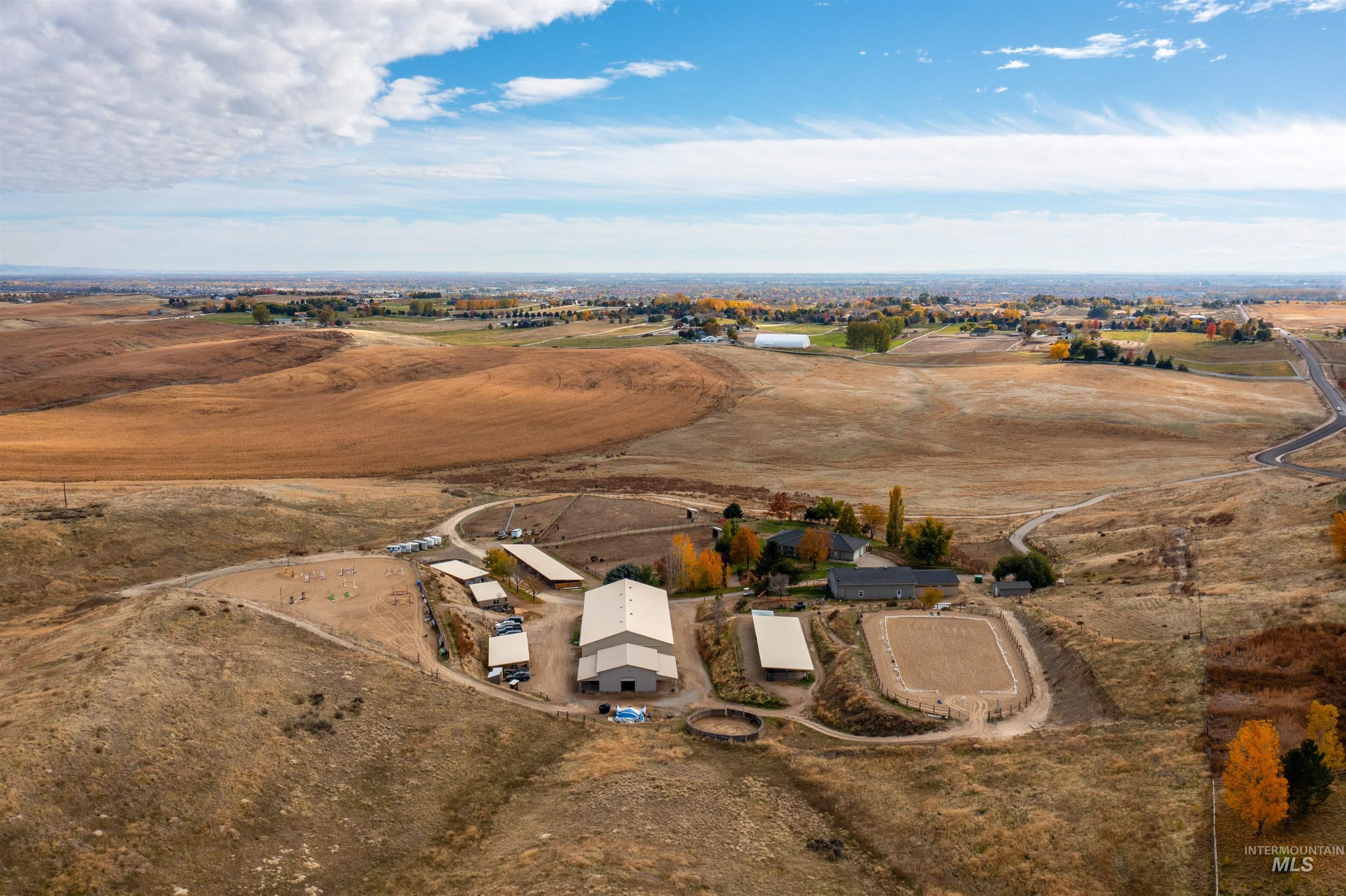 Aerial view of property and surrounding area featuring rural landscape