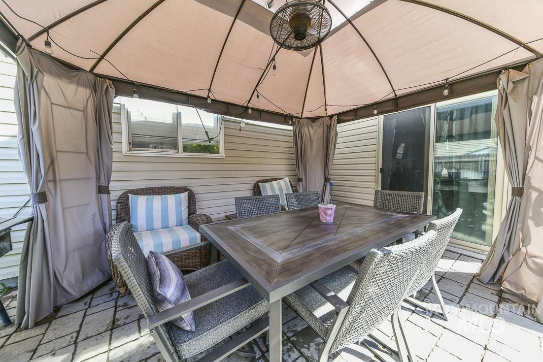 Wooden deck featuring outdoor dining space, a patio, and a gazebo