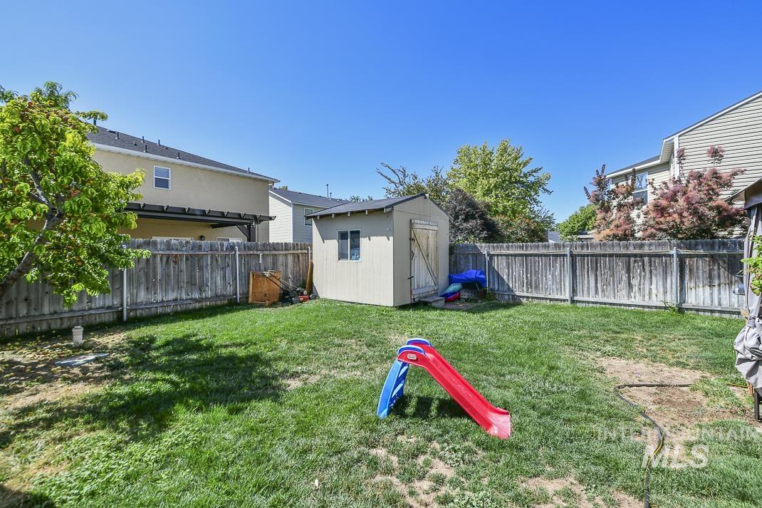Fenced backyard with a shed