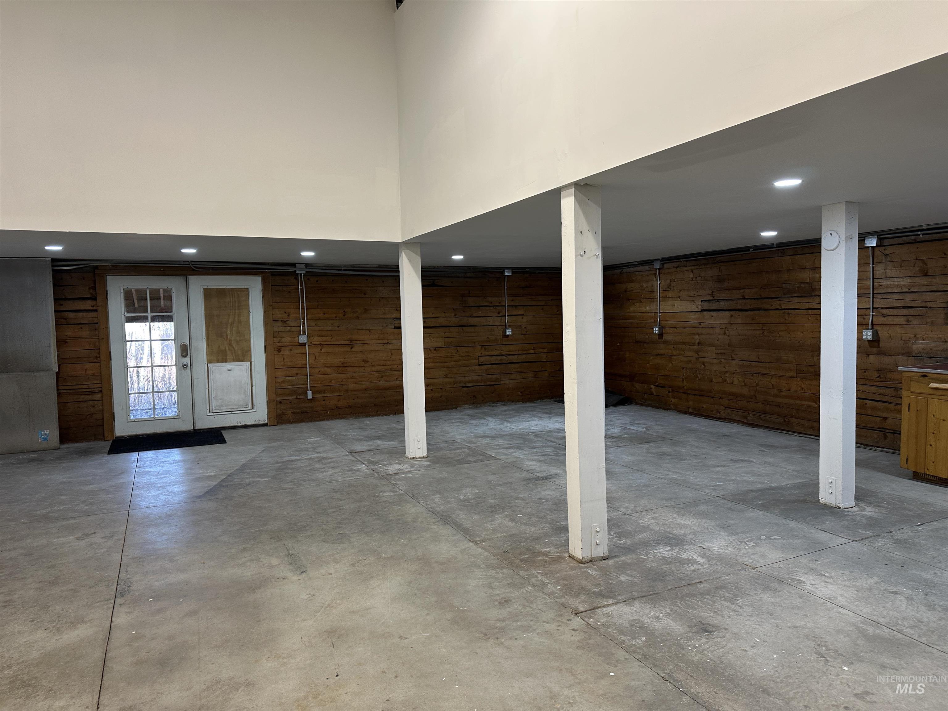 Basement with recessed lighting and wooden walls