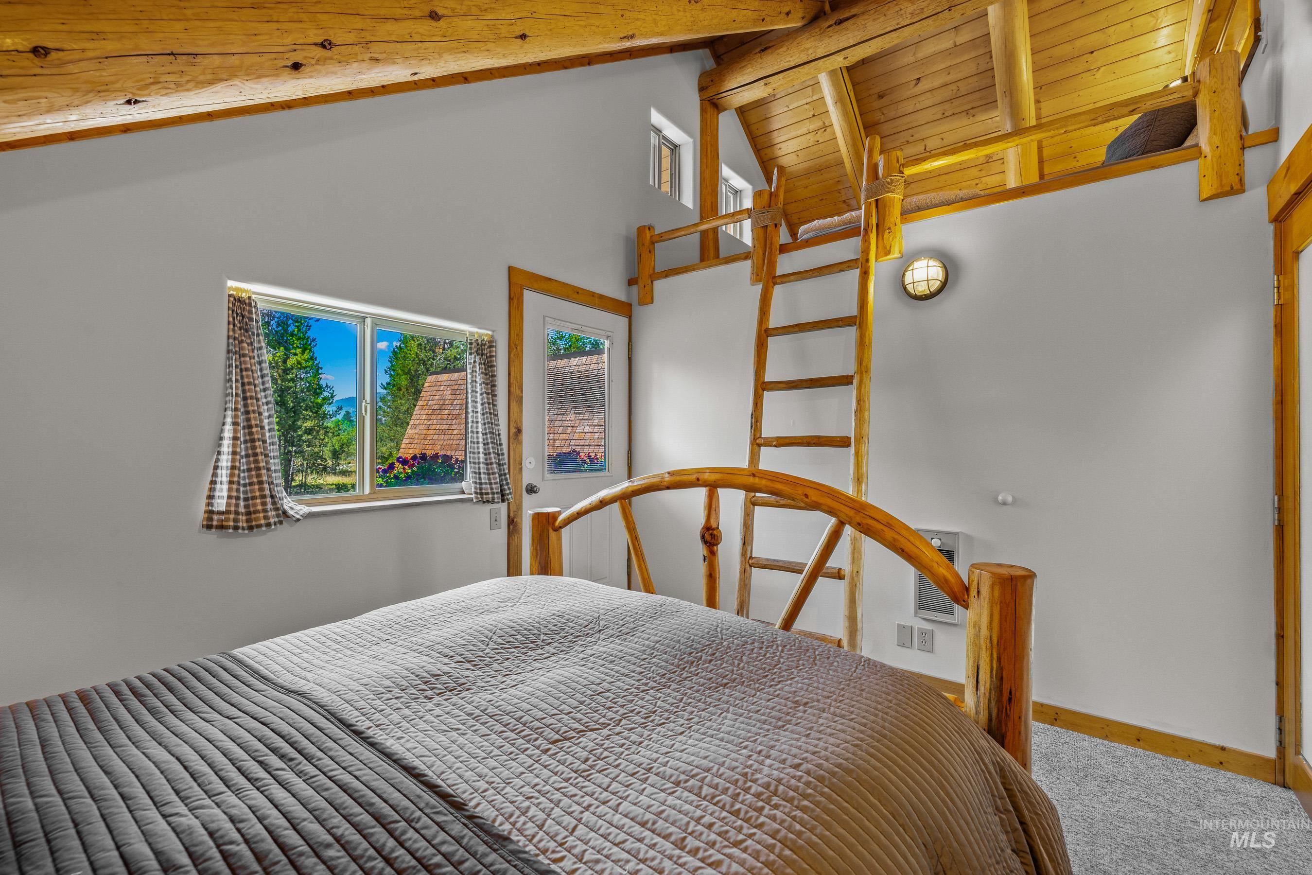 Bedroom featuring beamed ceiling, carpet floors, and high vaulted ceiling