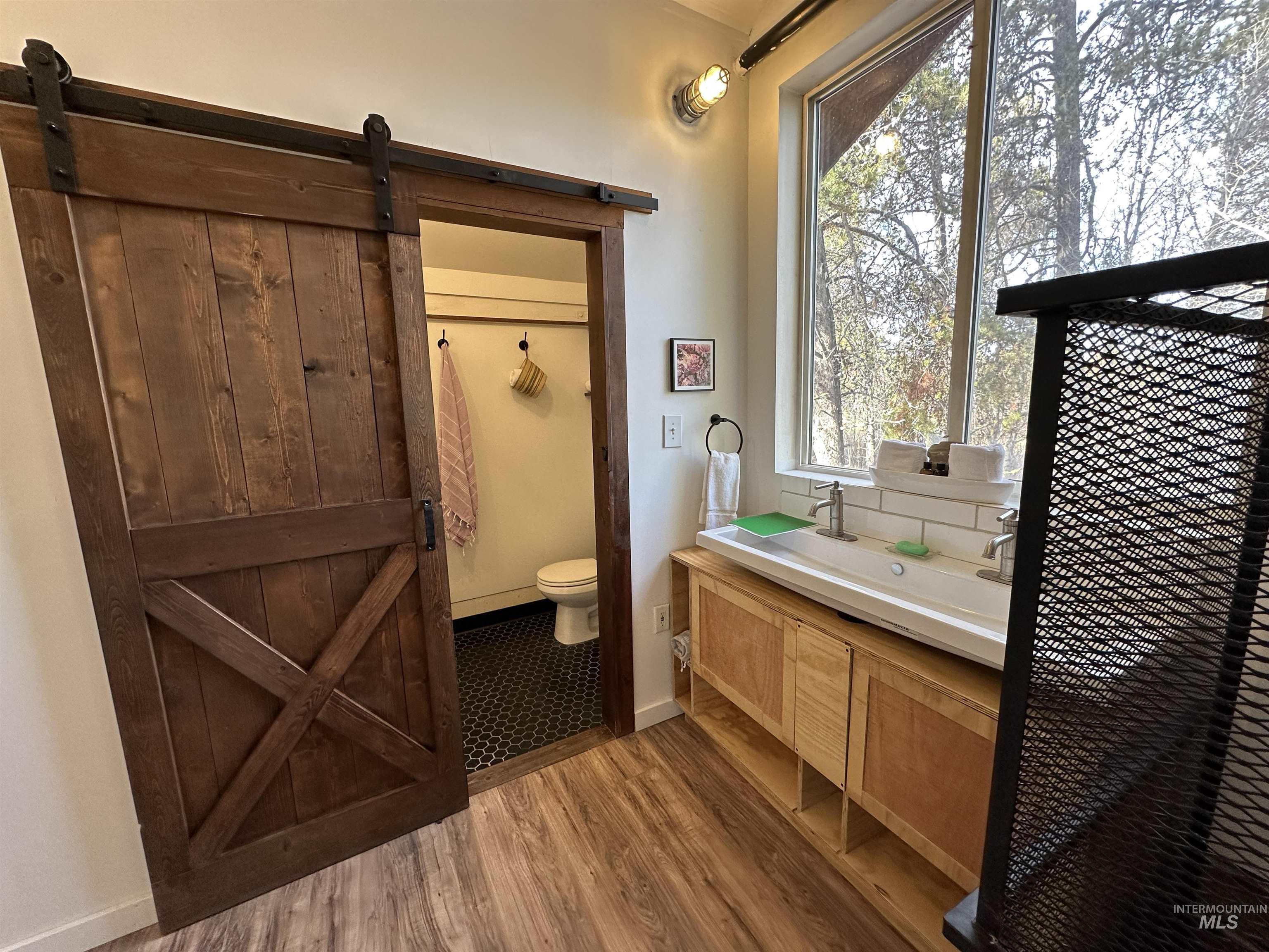 Bathroom featuring light wood-style flooring and vanity