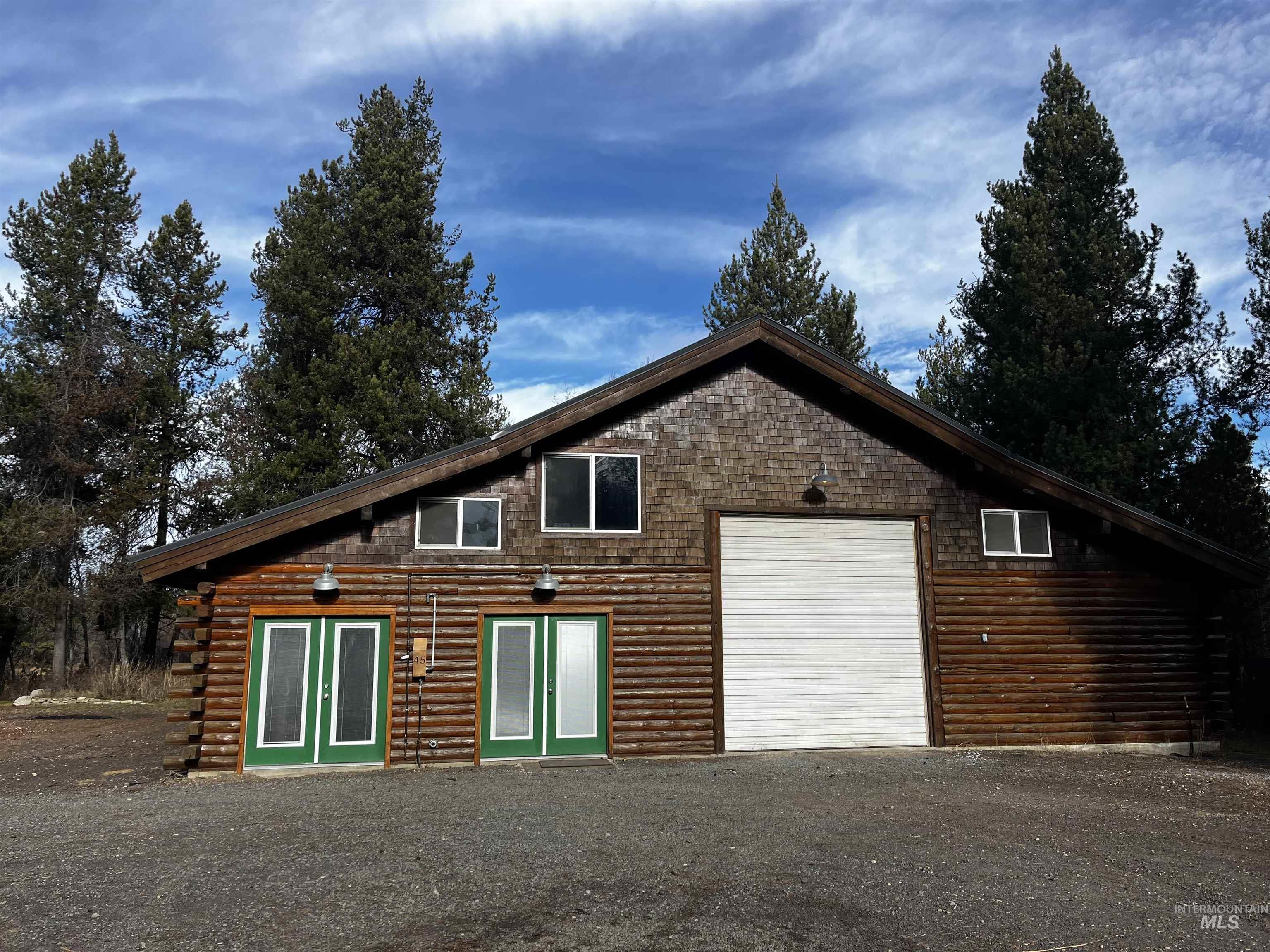 View of home's exterior featuring log siding and a garage