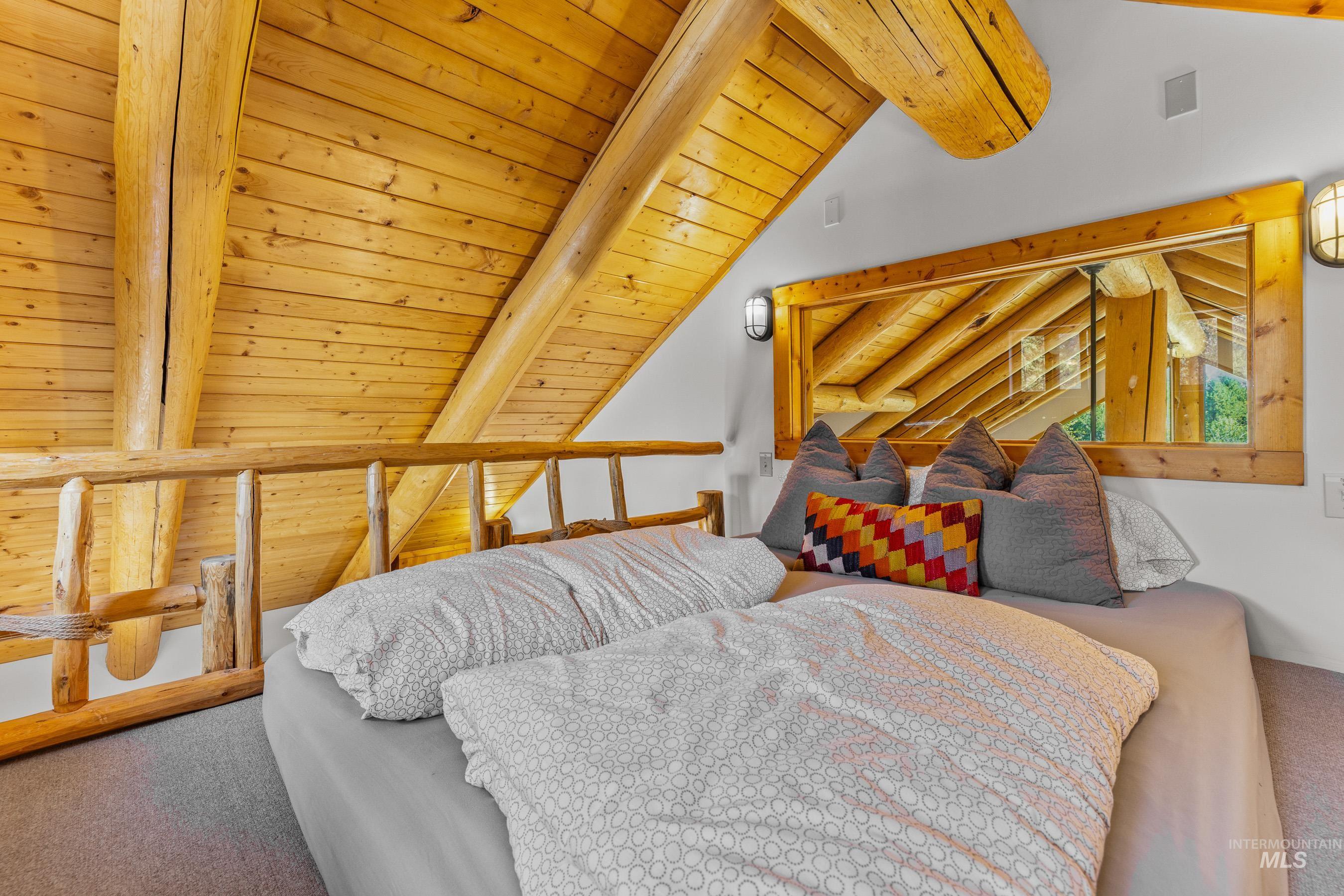 Bedroom featuring carpet floors and wood ceiling