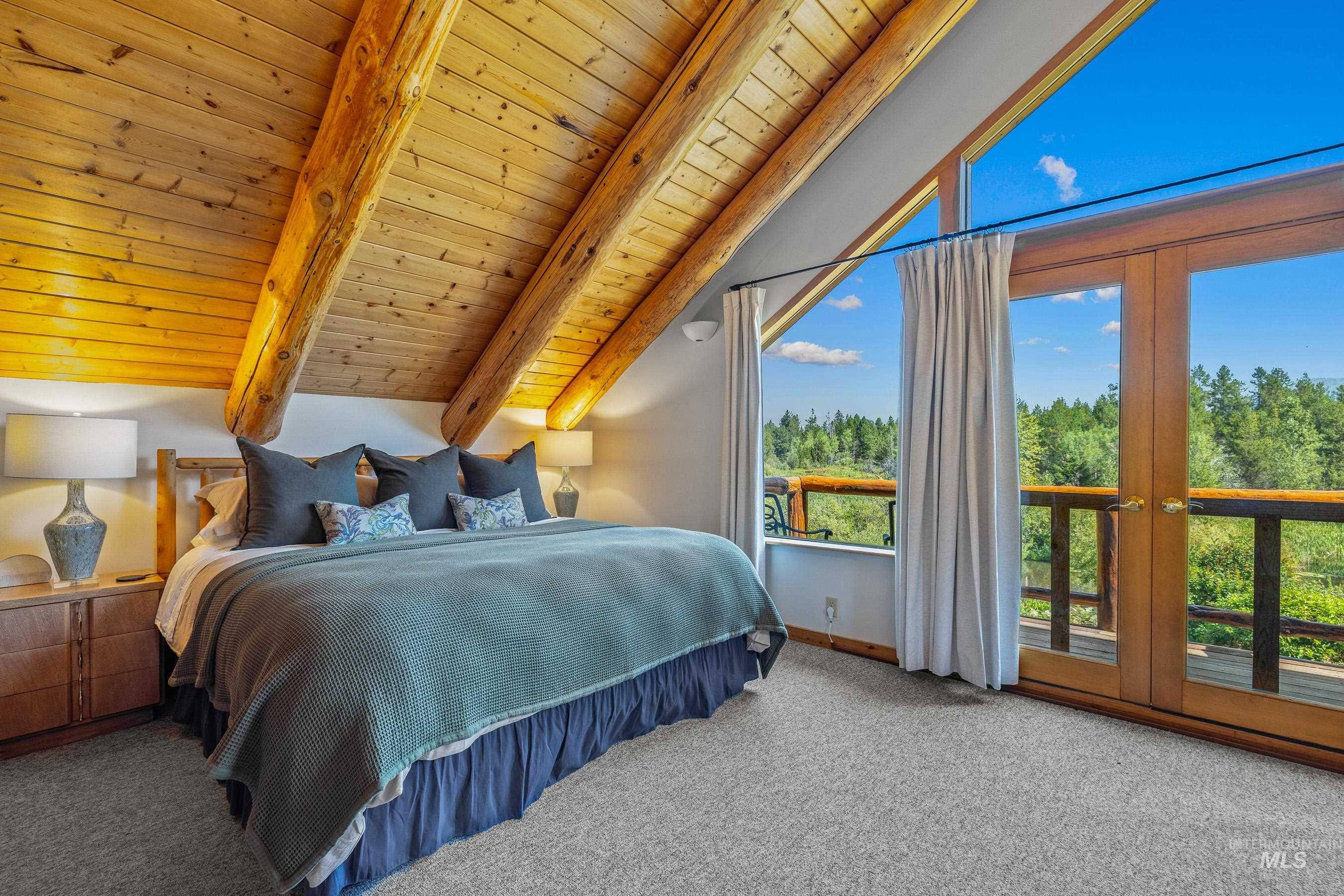 Bedroom with carpet, wood ceiling, and french doors