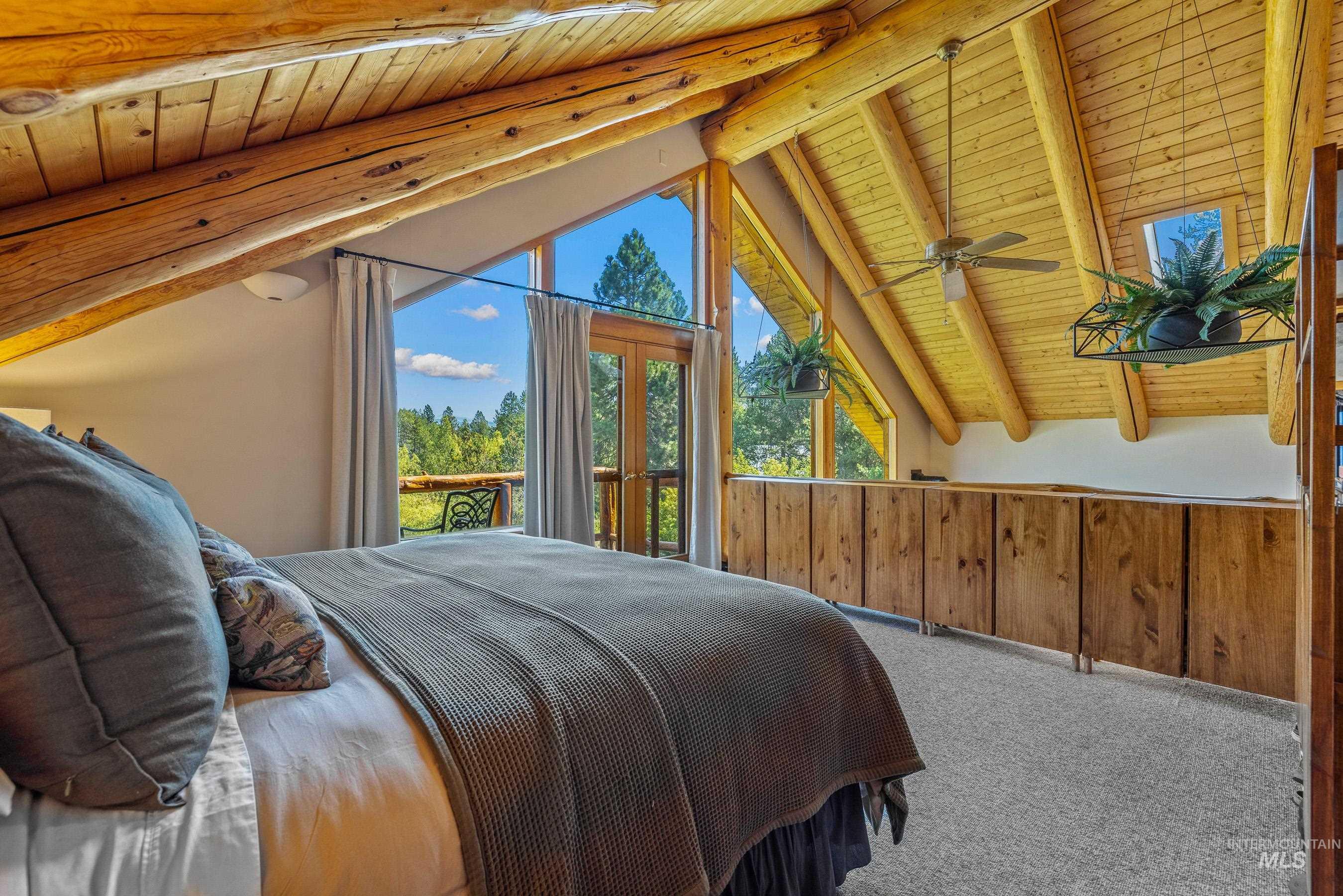 Carpeted bedroom with wooden ceiling, access to outside, wooden walls, and french doors