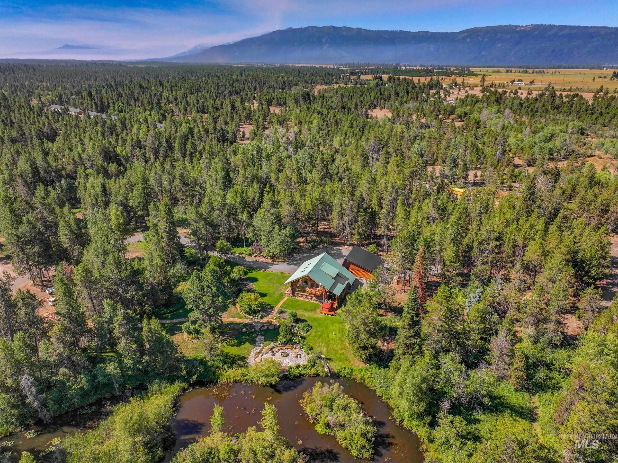View of property location featuring a heavily wooded area and a water and mountain view