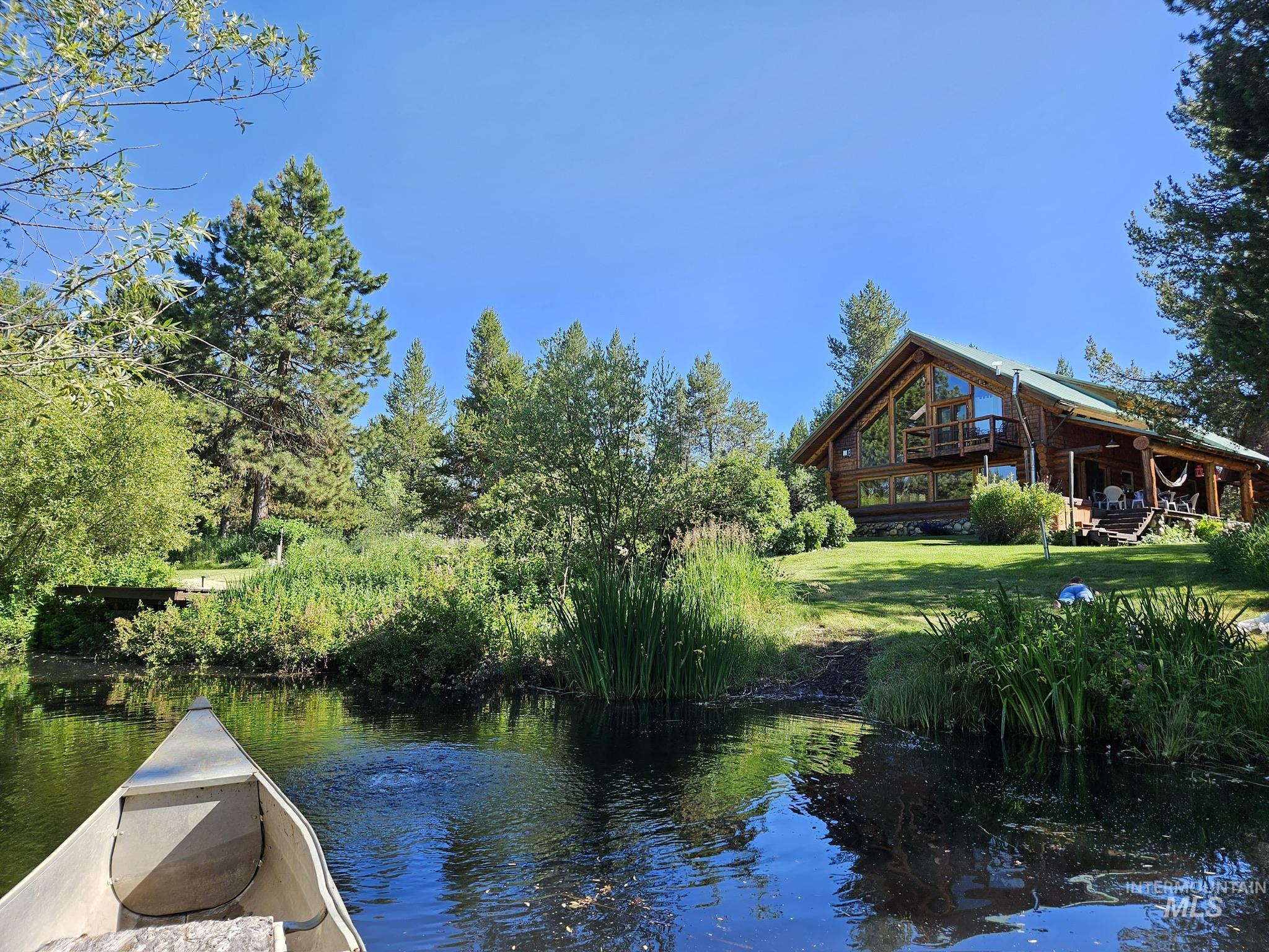 Dock area featuring a yard and a deck with water view