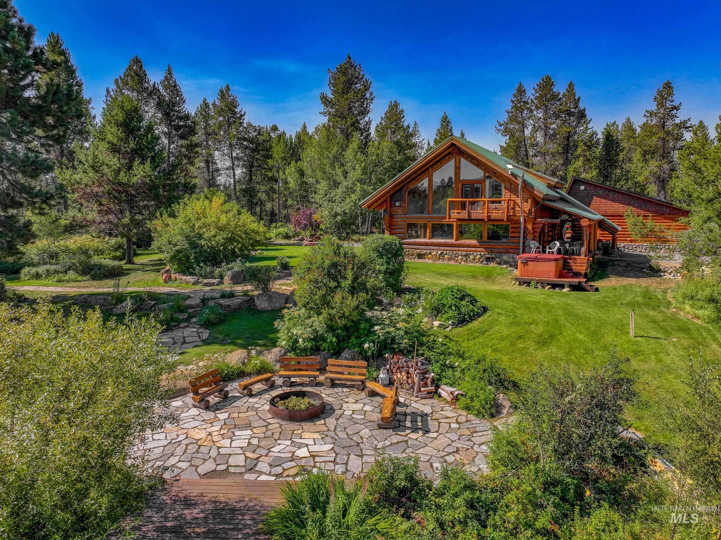 Rear view of house featuring a yard, an outdoor fire pit, and a patio