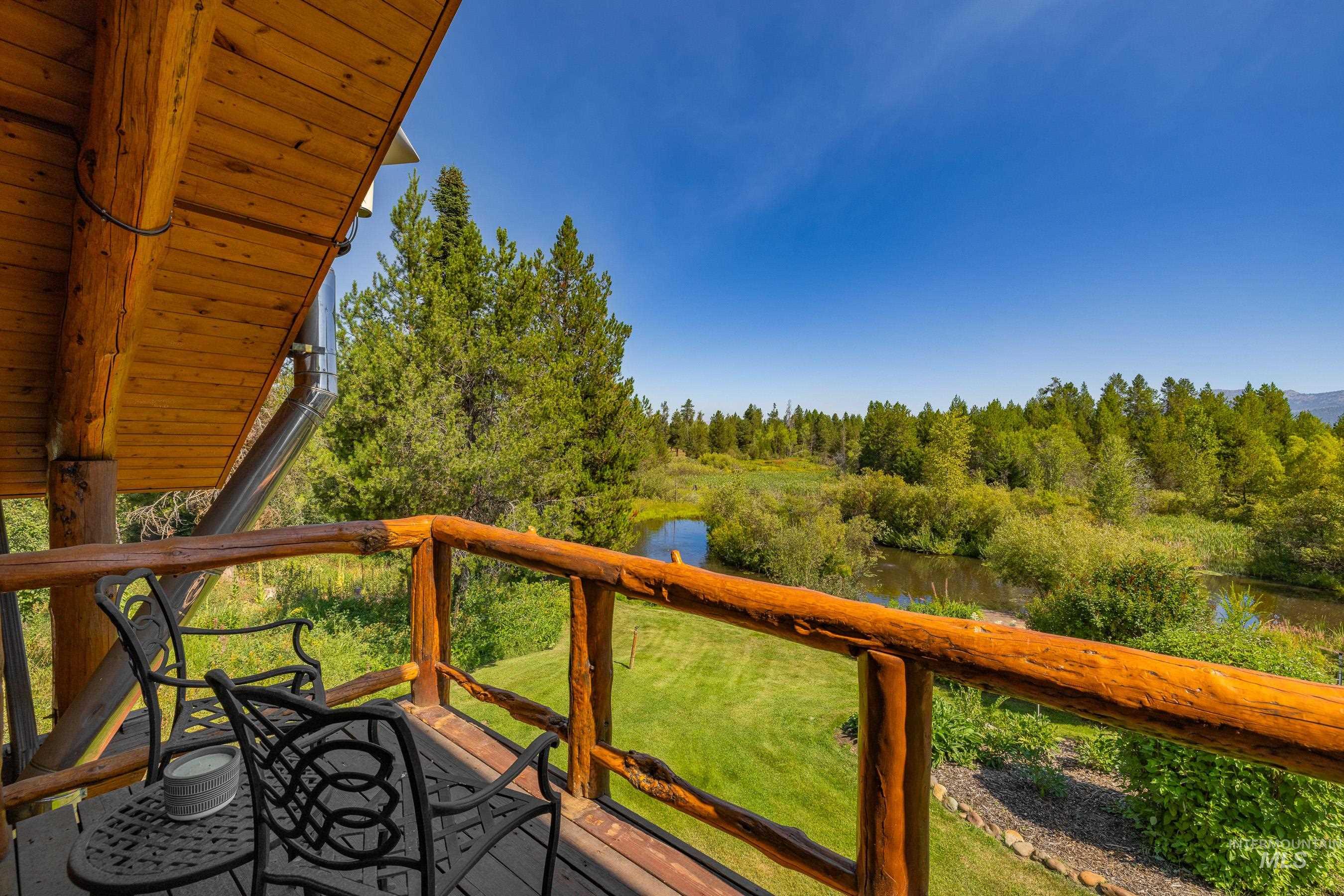 Deck featuring a water view and a lawn
