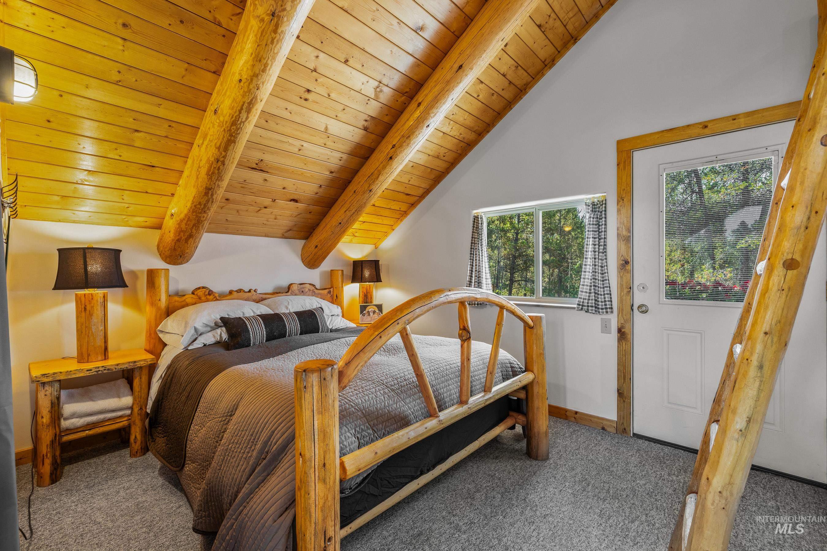 Carpeted bedroom with wooden ceiling