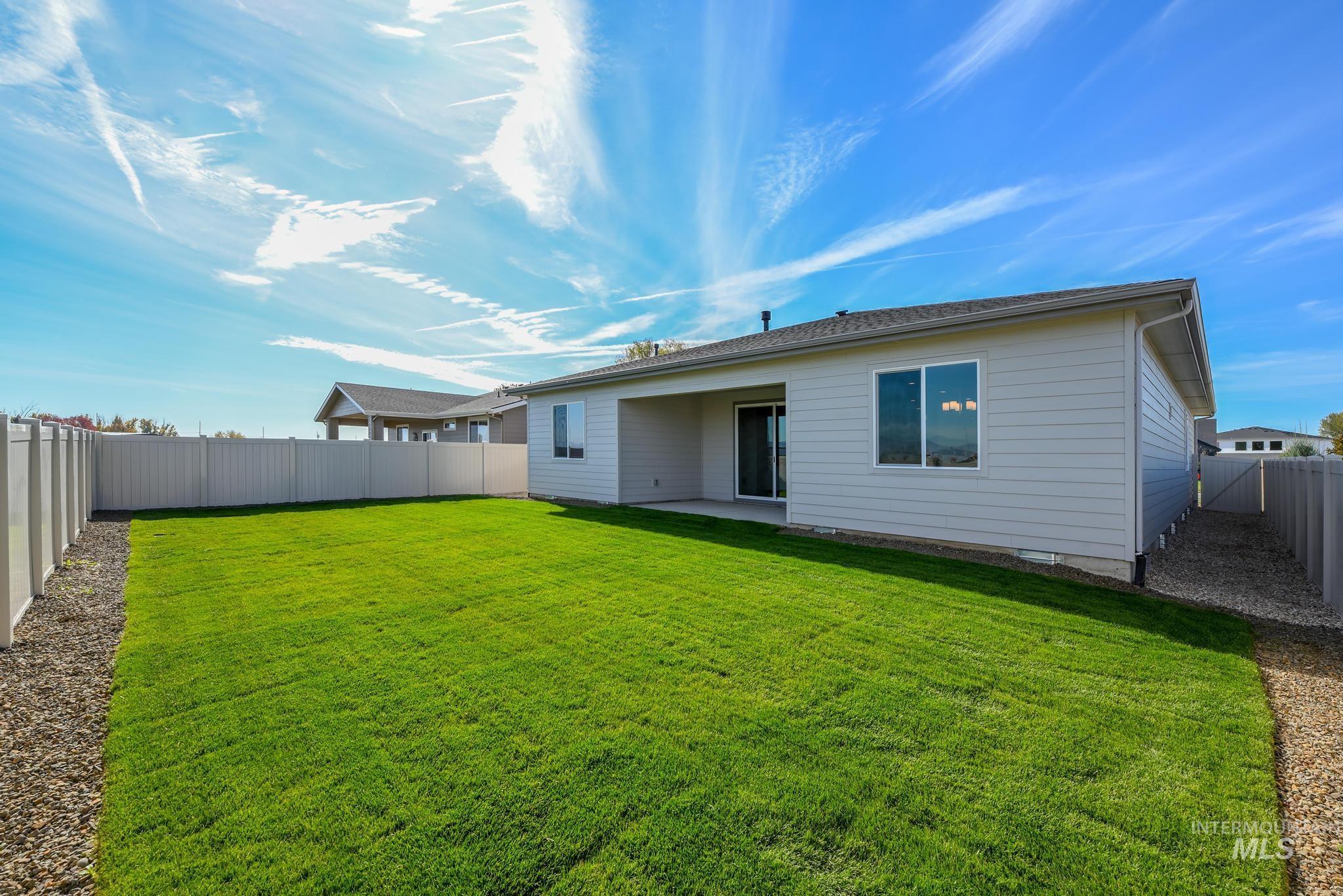 Rear view of property featuring a patio and a fenced backyard