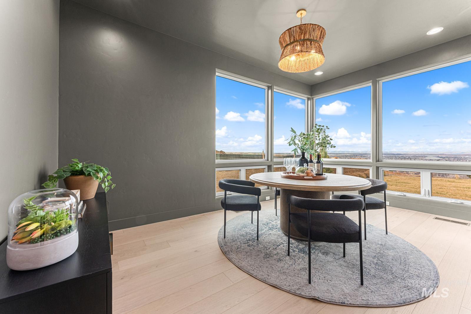 Dining room with light wood-style flooring and recessed lighting