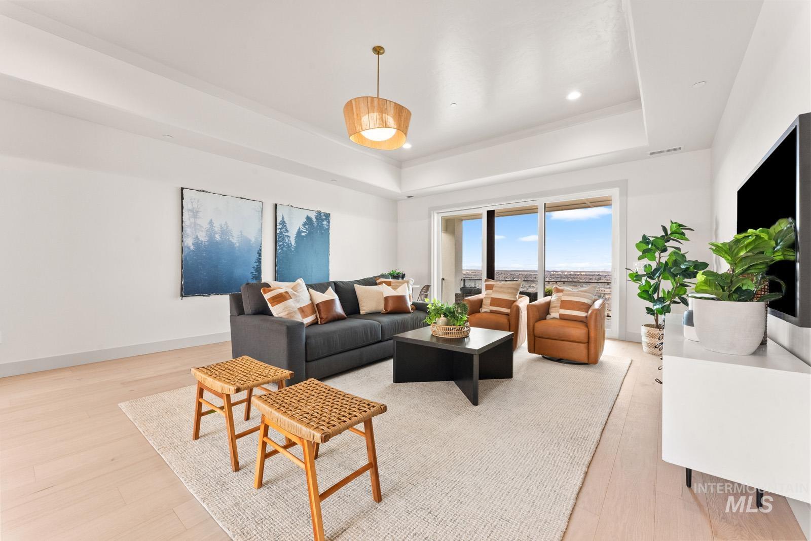 Living area featuring light wood-style flooring and baseboards
