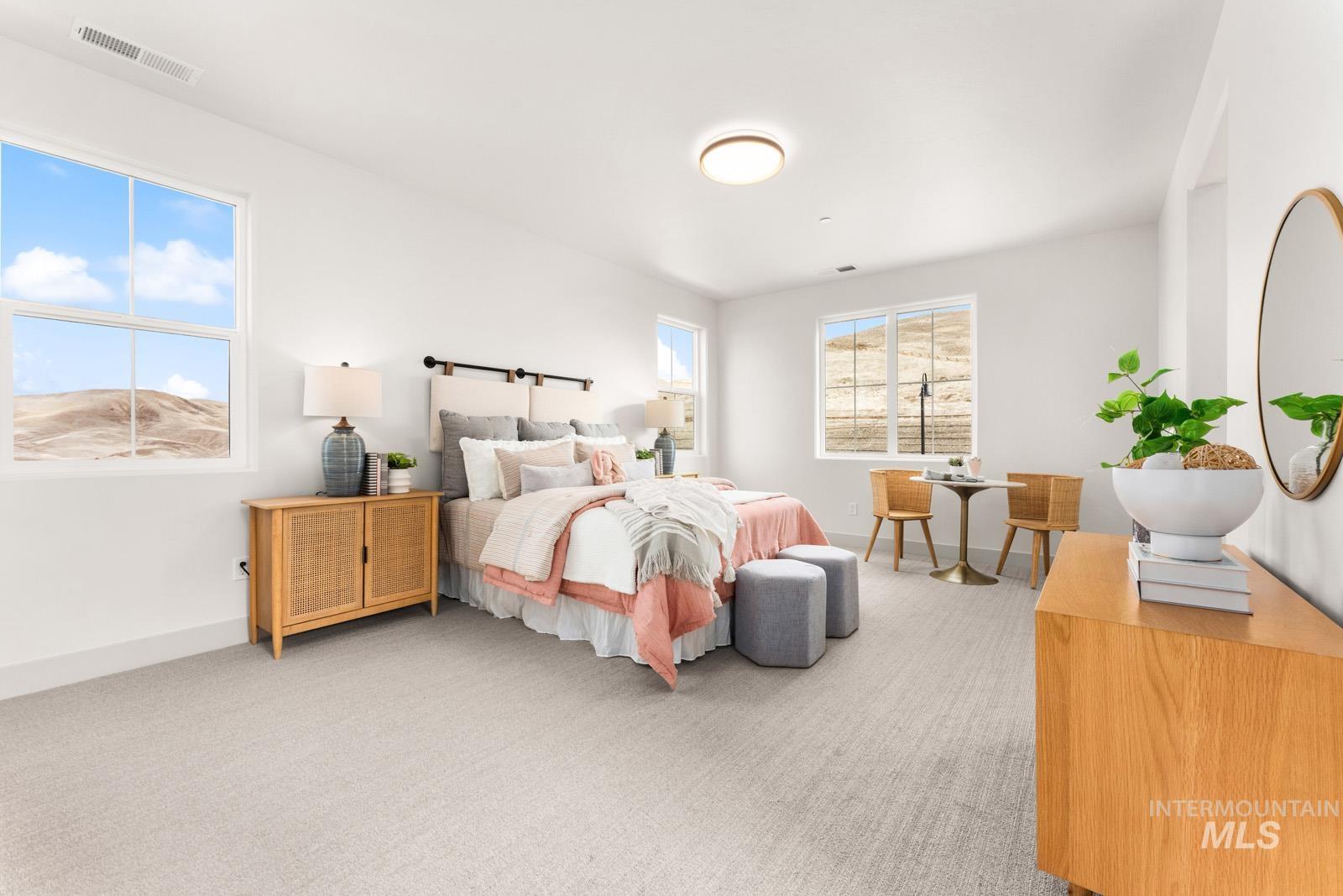 Bedroom featuring light colored carpet and baseboards