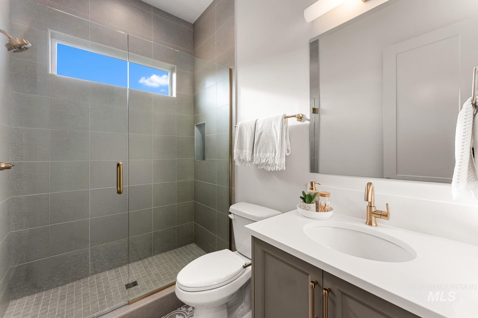 Full bathroom with vanity and a stall shower