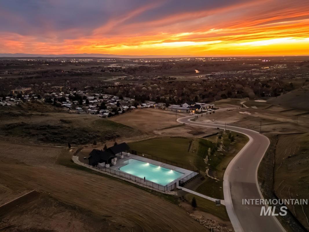 Aerial view at dusk of view of pool area