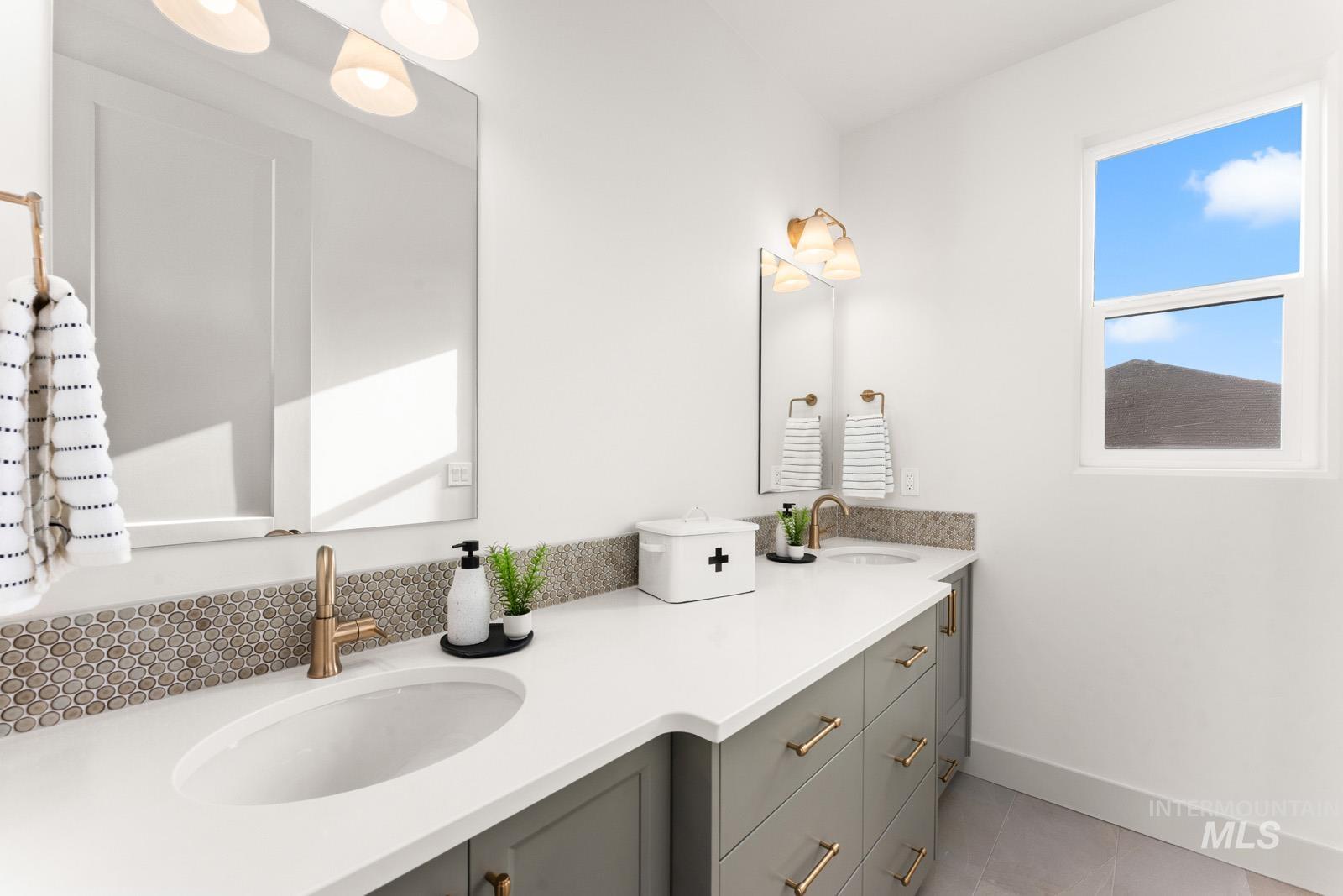 Bathroom featuring double vanity and light tile patterned flooring