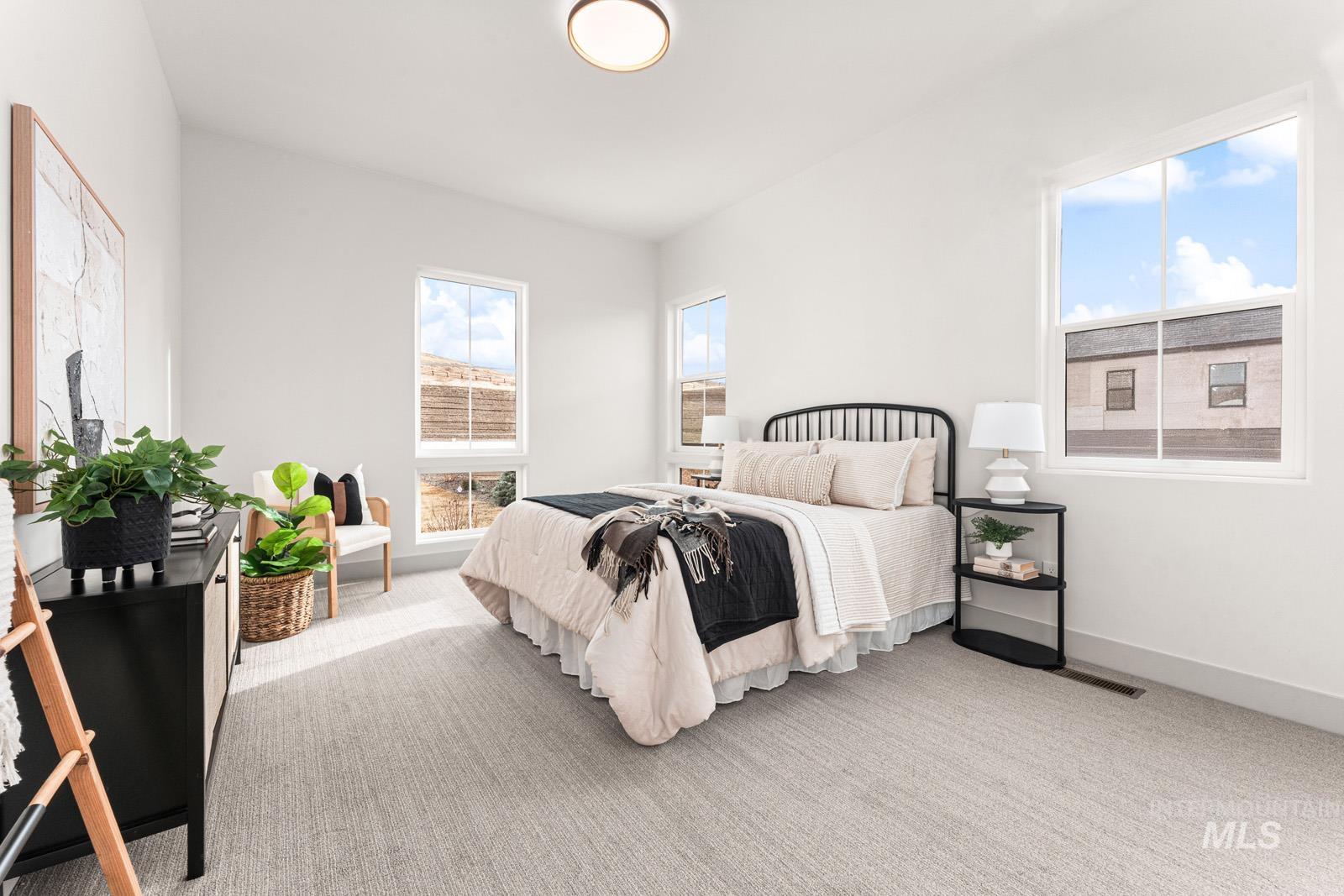 Bedroom featuring light colored carpet and baseboards
