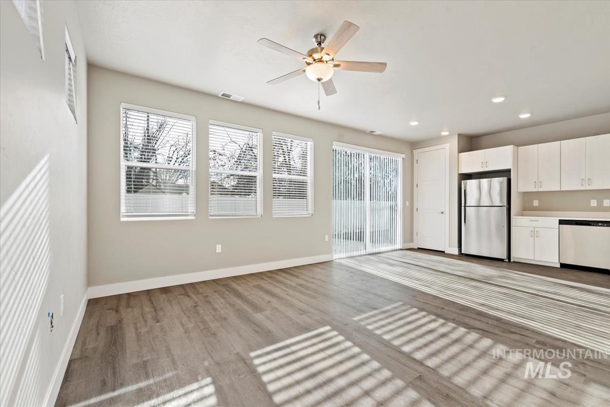 Unfurnished living room featuring light wood finished floors, a ceiling fan, and recessed lighting