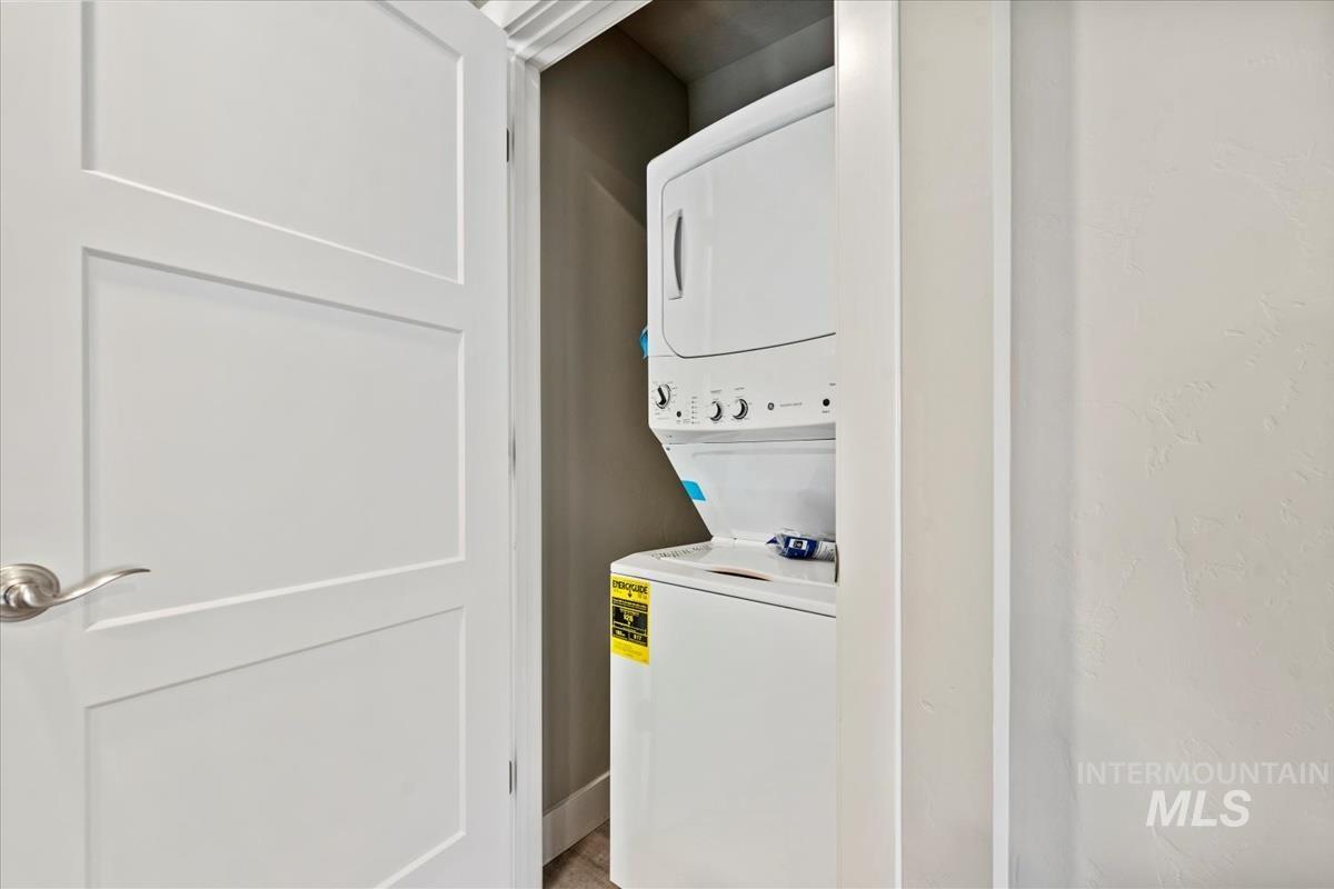 Laundry area featuring stacked washer and clothes dryer