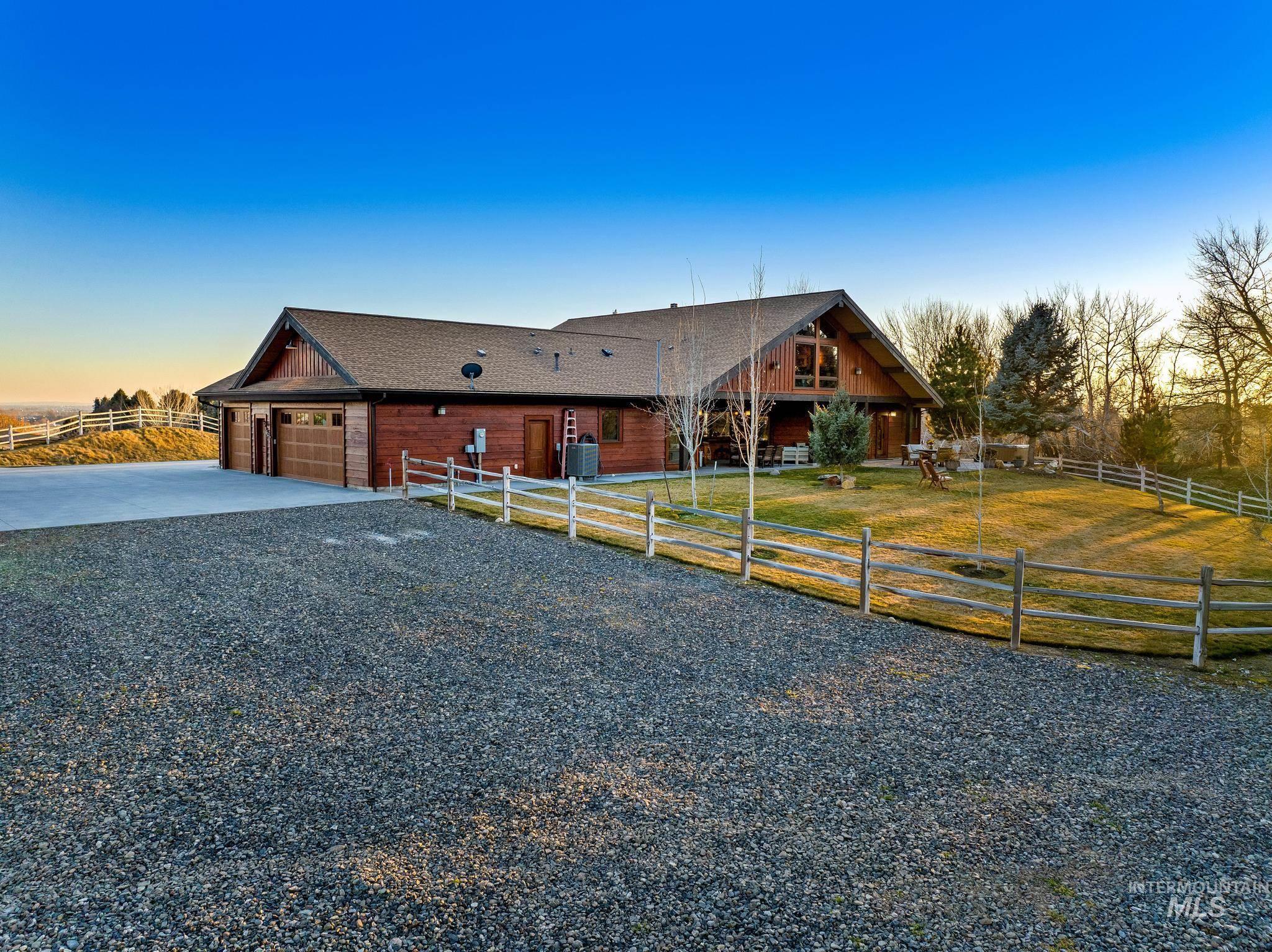 View of back of property with extended paved  and gravel driveway/