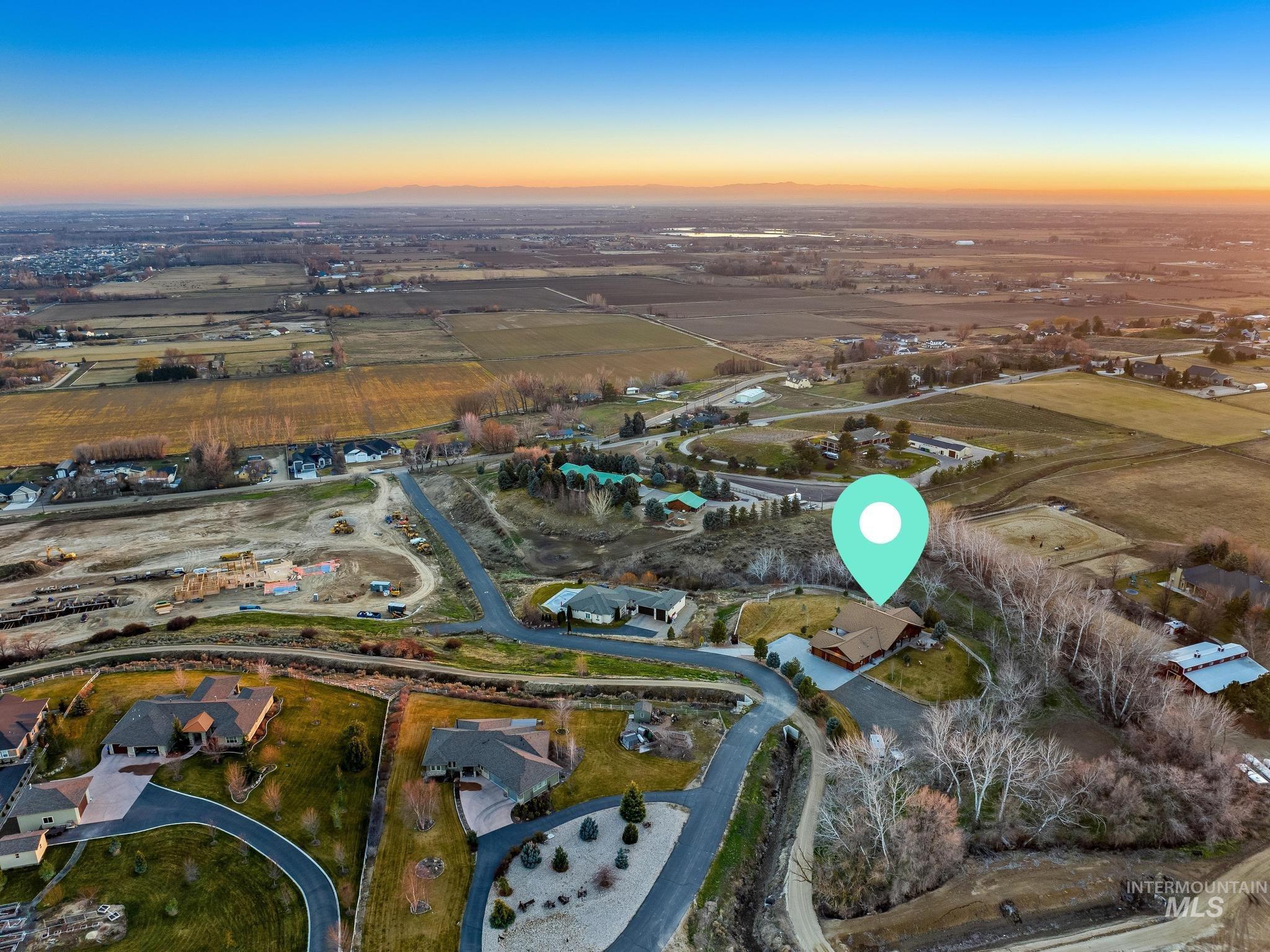Aerial overview of property's location featuring rural landscape and nearby suburban area
