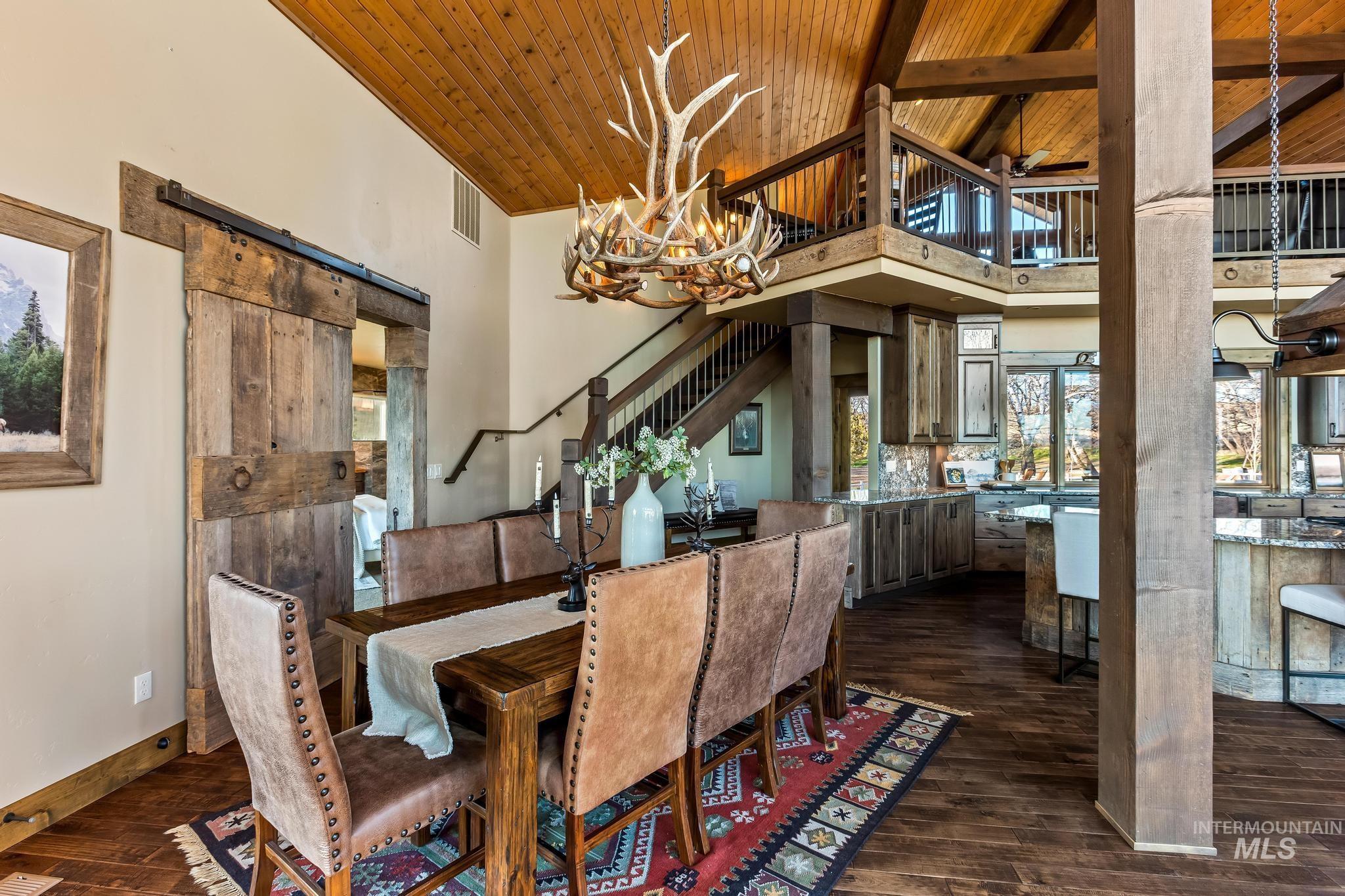 Dining room with custom chandelier, wood beamed ceiling