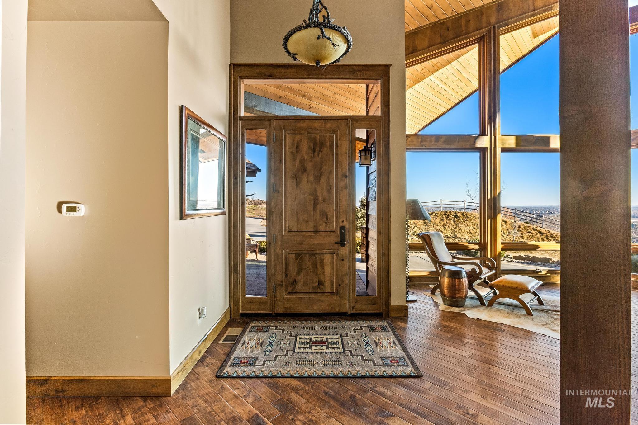 Entrance foyer with dark wood finished floors and baseboards