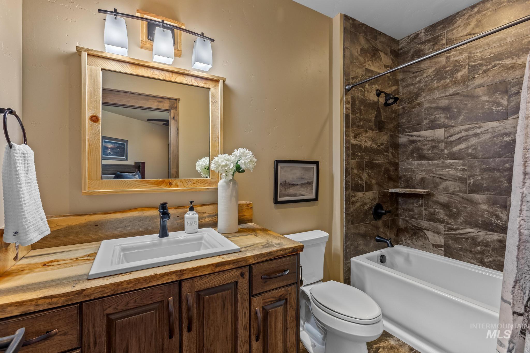 Full bathroom featuring bathtub / shower combination with custom tile work