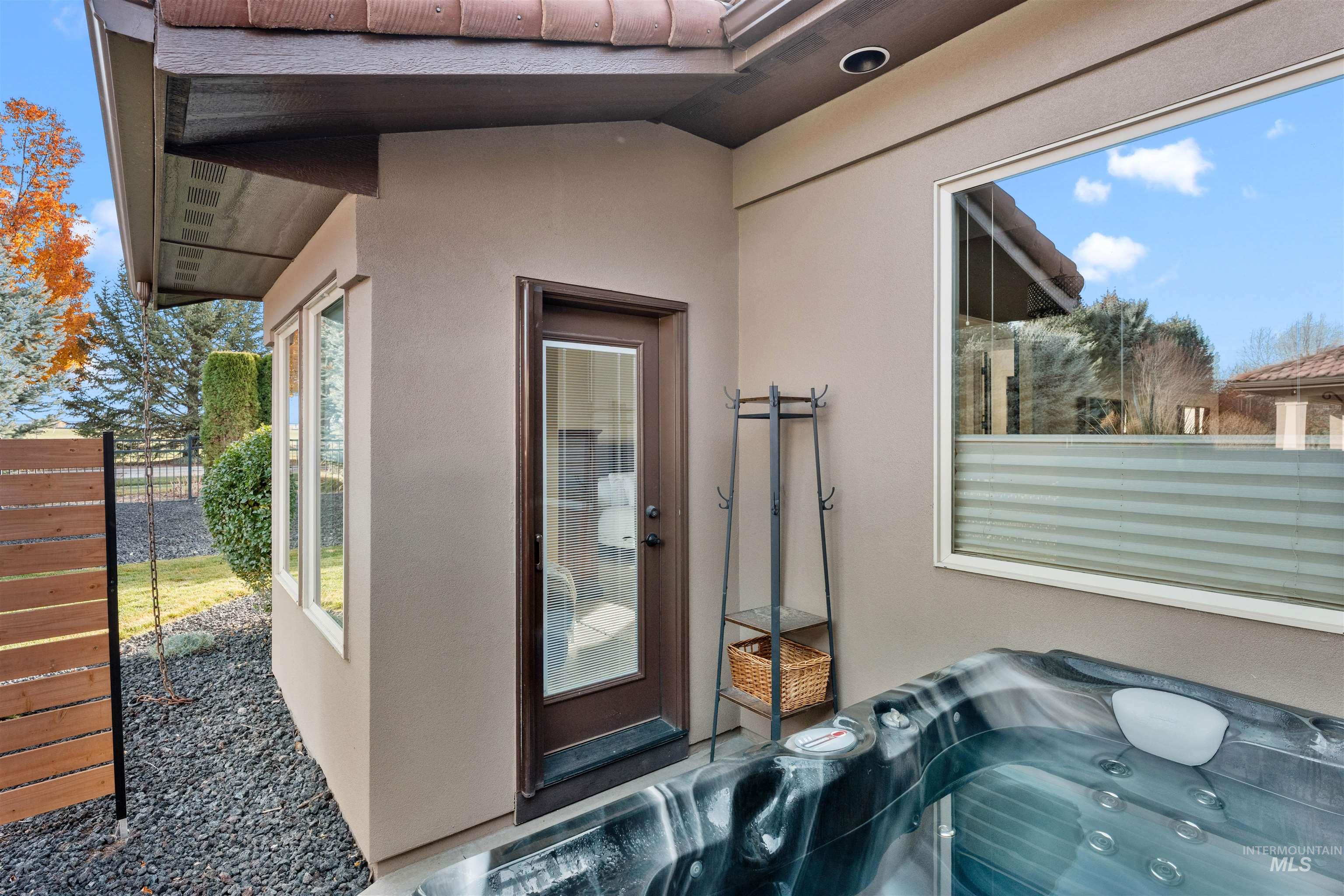Exterior view of a hot tub and stucco siding